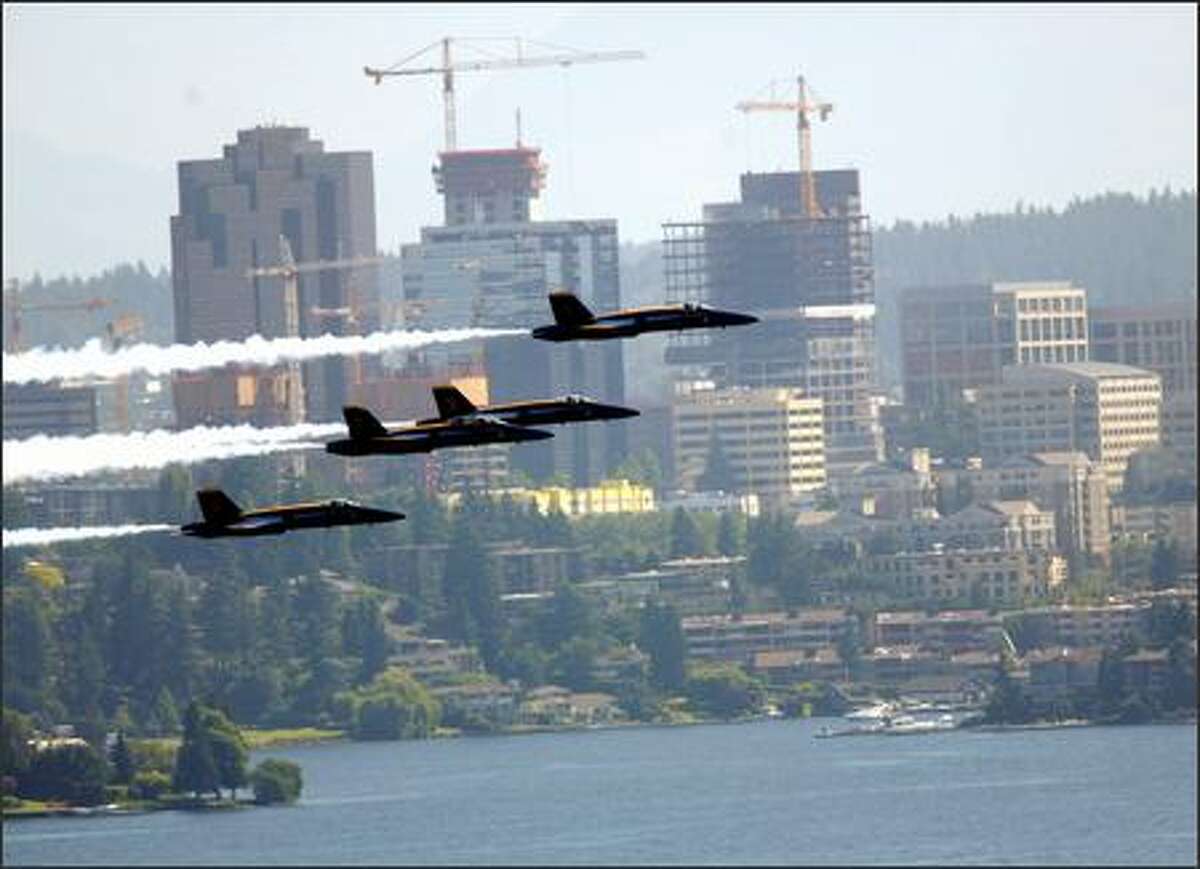 The Blue Angels fly past the downtown Bellevue skyline, as seen from the vicinity of 32nd Avenue South and South Judkins Street in Seattle.