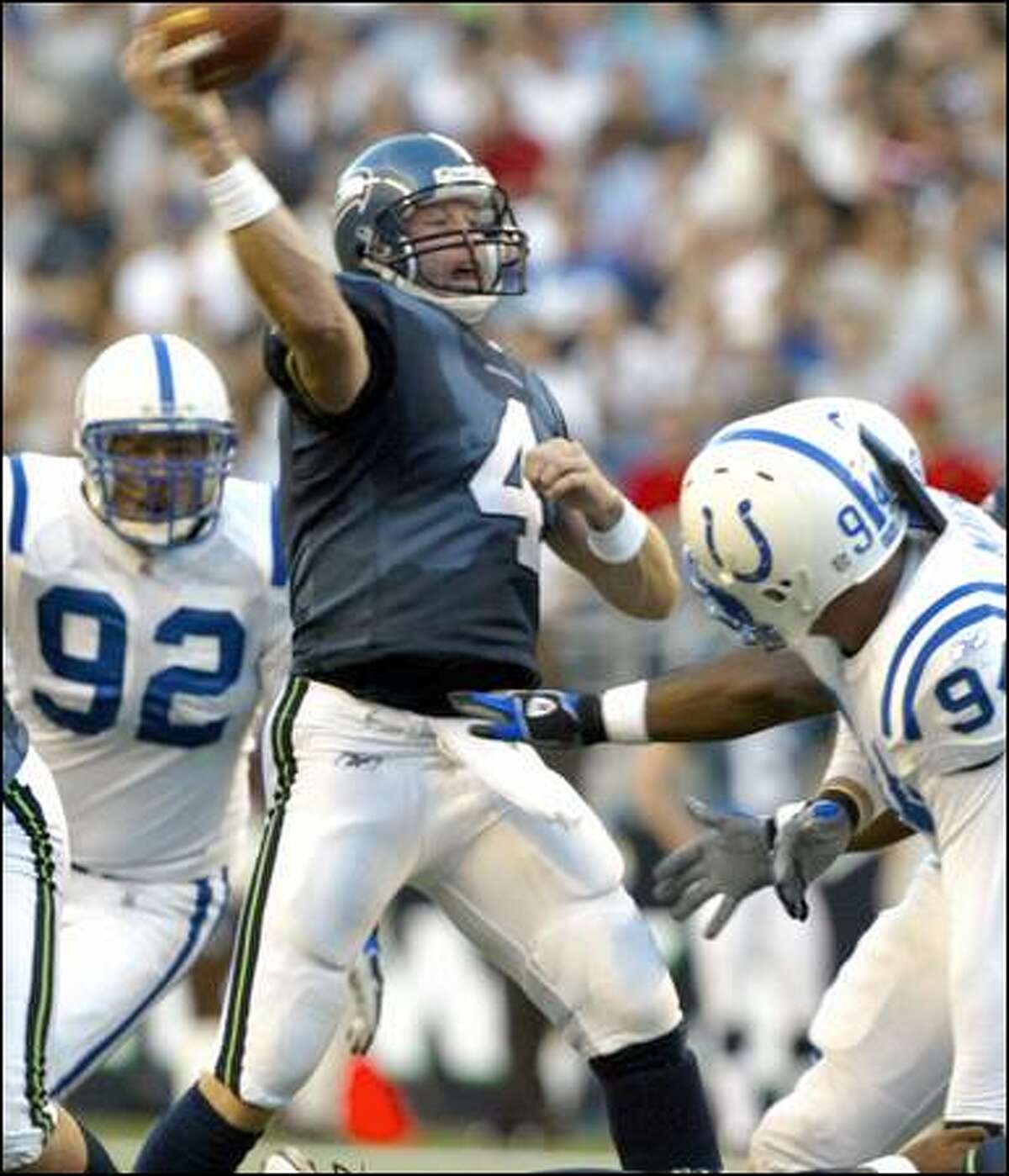 Trent Dilfer throws a pass in the first quarter before his injury.