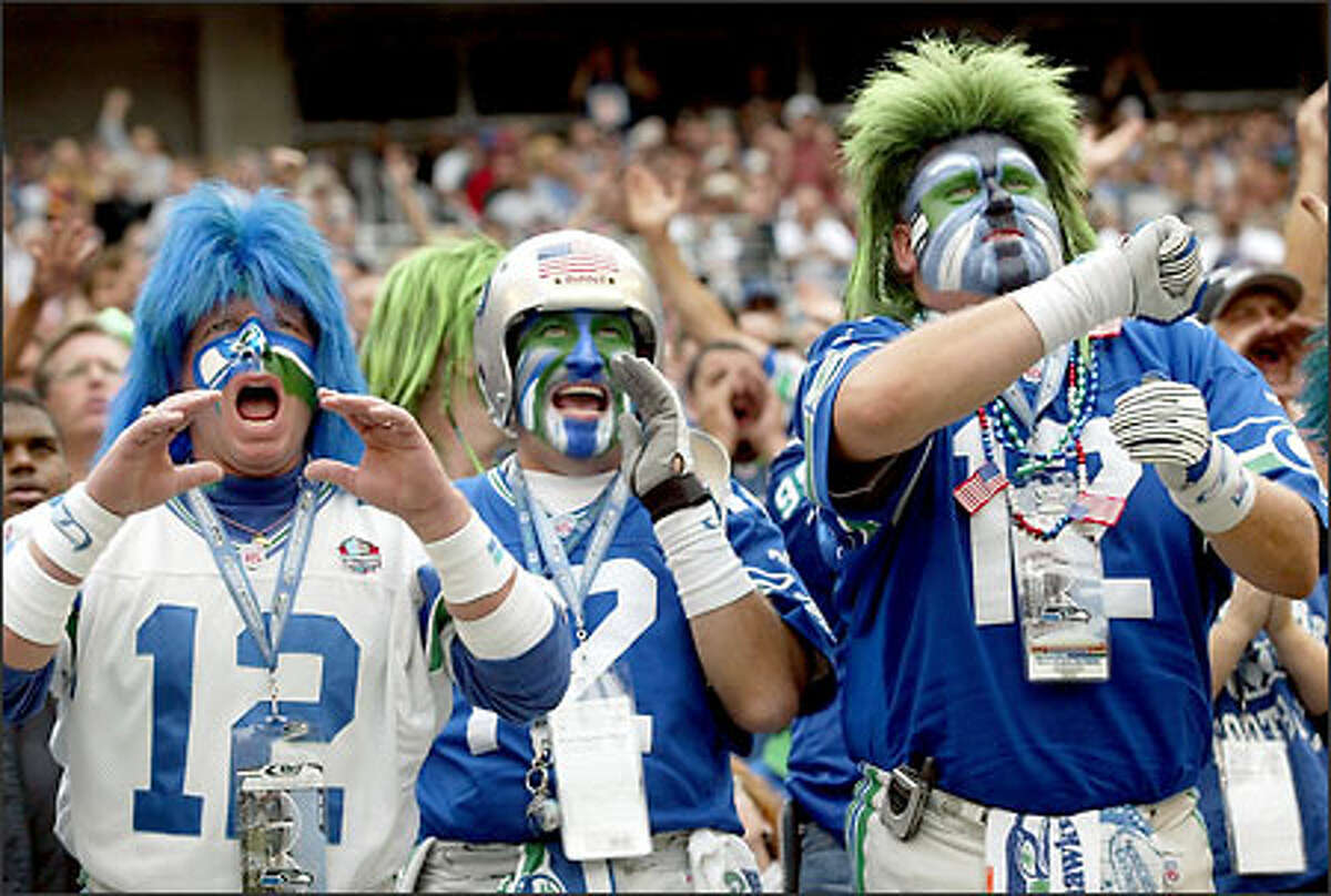 Seahawks fans Jeff Schumaier, Brad Carter and Bruce McMillian cheer on the defense in the fourth quarter.