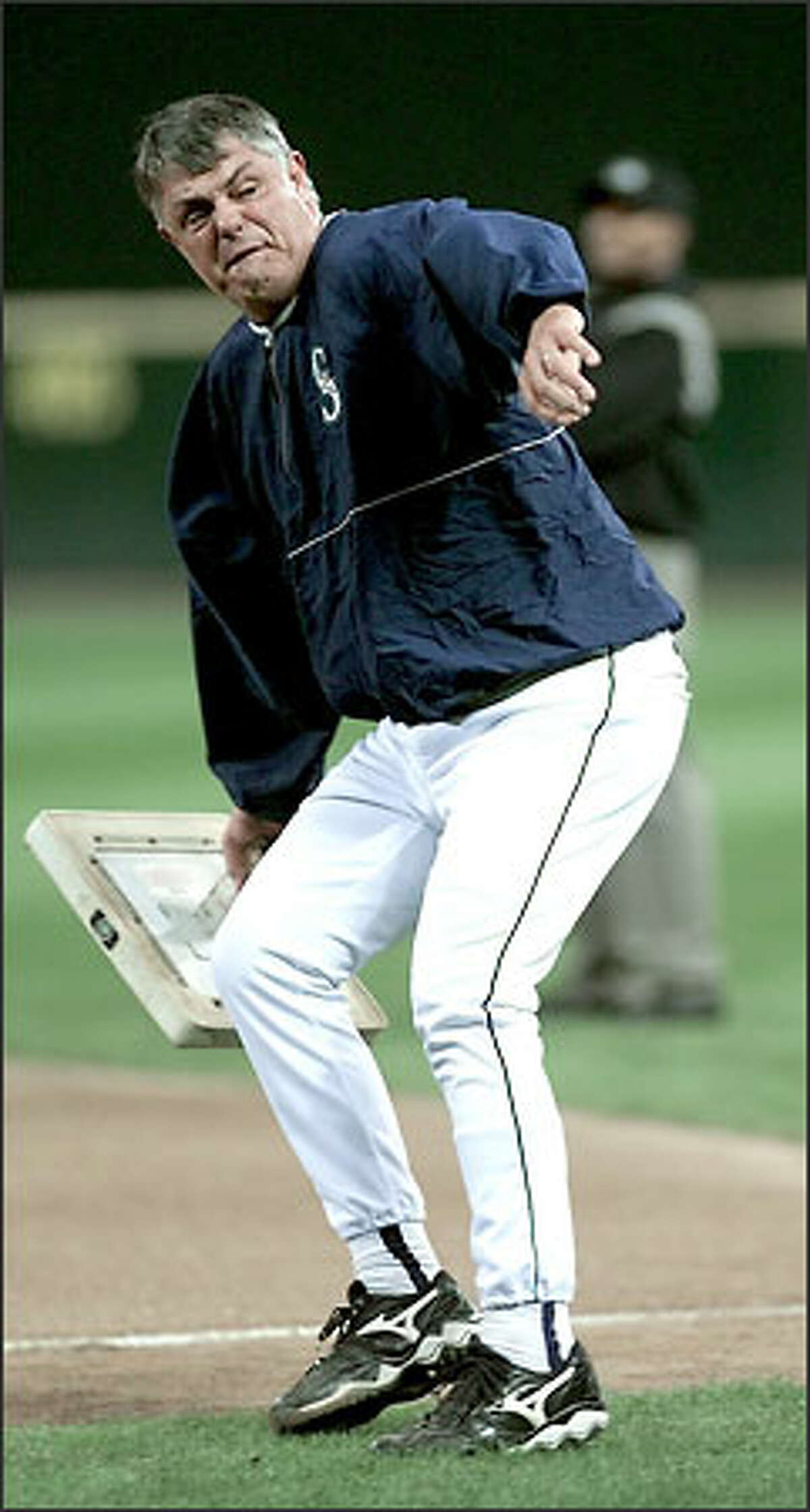 Mariners manager Lou Piniella throws first base in a fit of utter rage during a game against Texas on Sept. 18 at Safeco Field. Piniella went nuts after a bad call and an ensuing "smirk" from the first-base umpire.