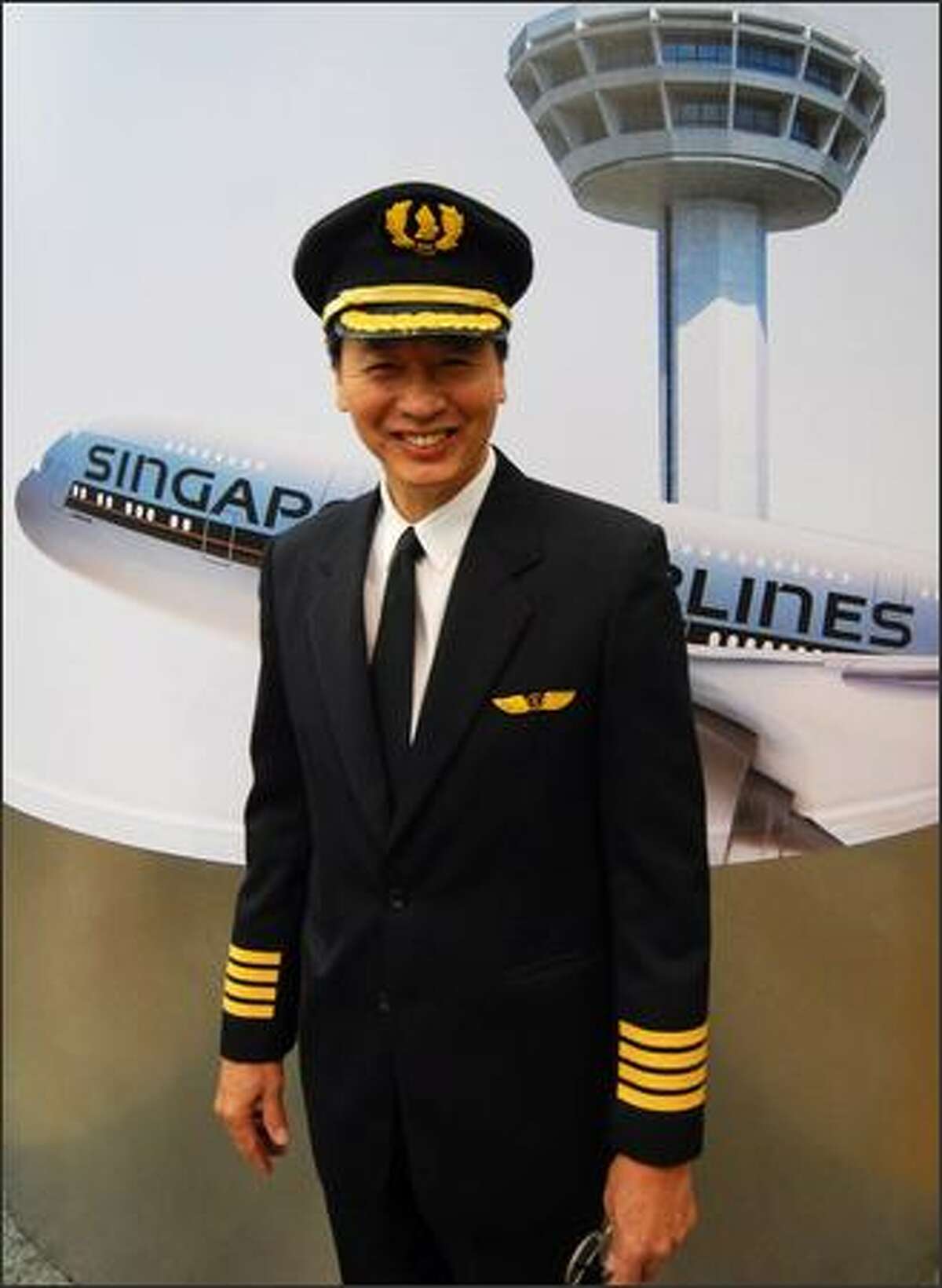 Captain Robert Ting poses for photographers before the maiden flight.