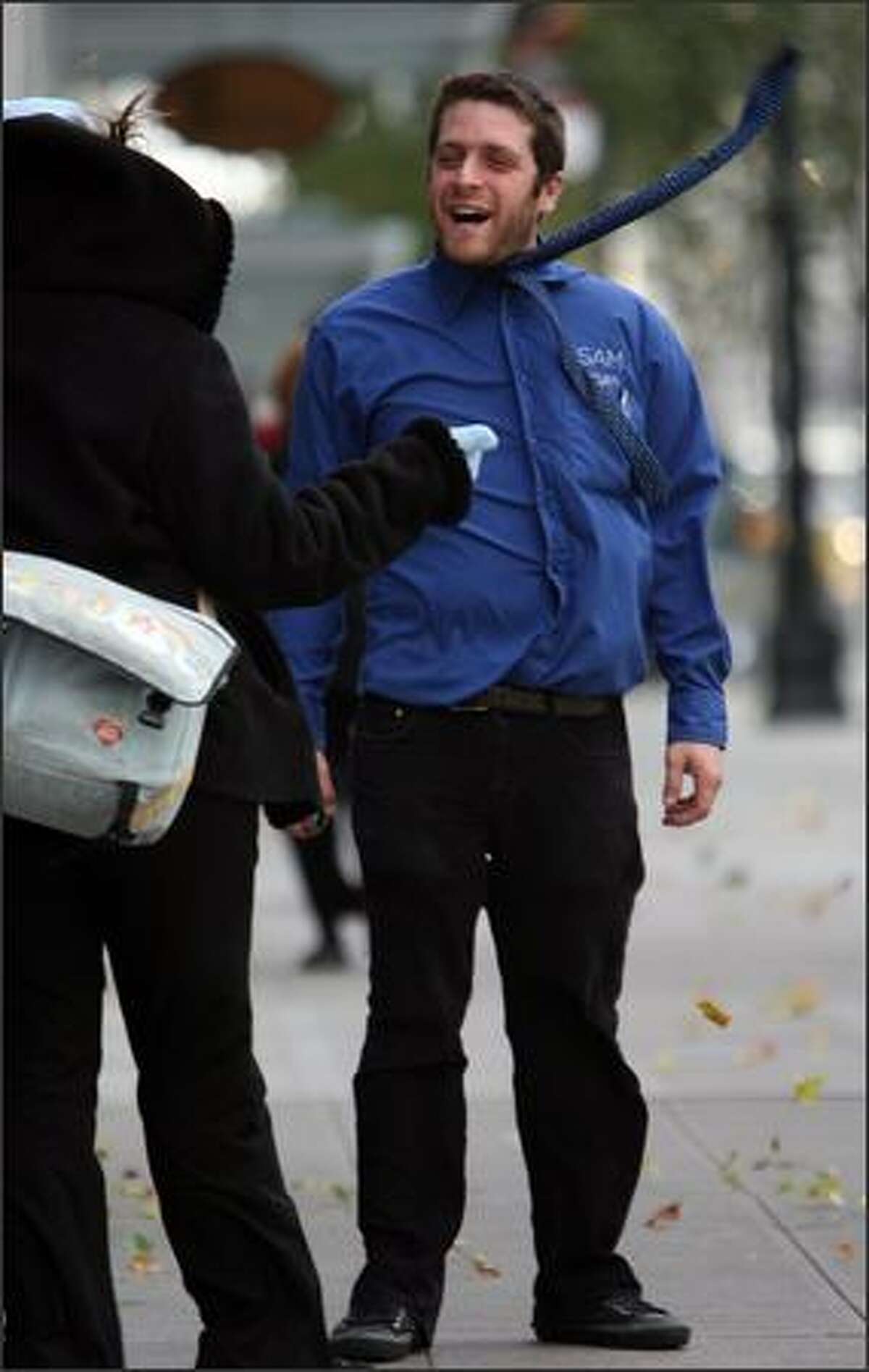 Rob Femur, who works at the Seattle Art Museum, comes untied as high winds rip through downtown Seattle.