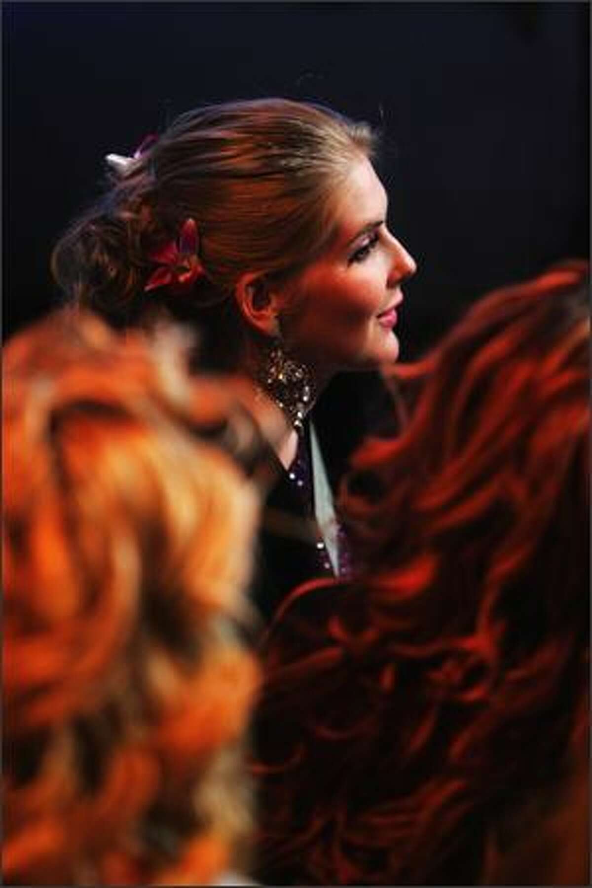Caroline Pemberton, Miss Australia 2007, looks on in a TV studio.