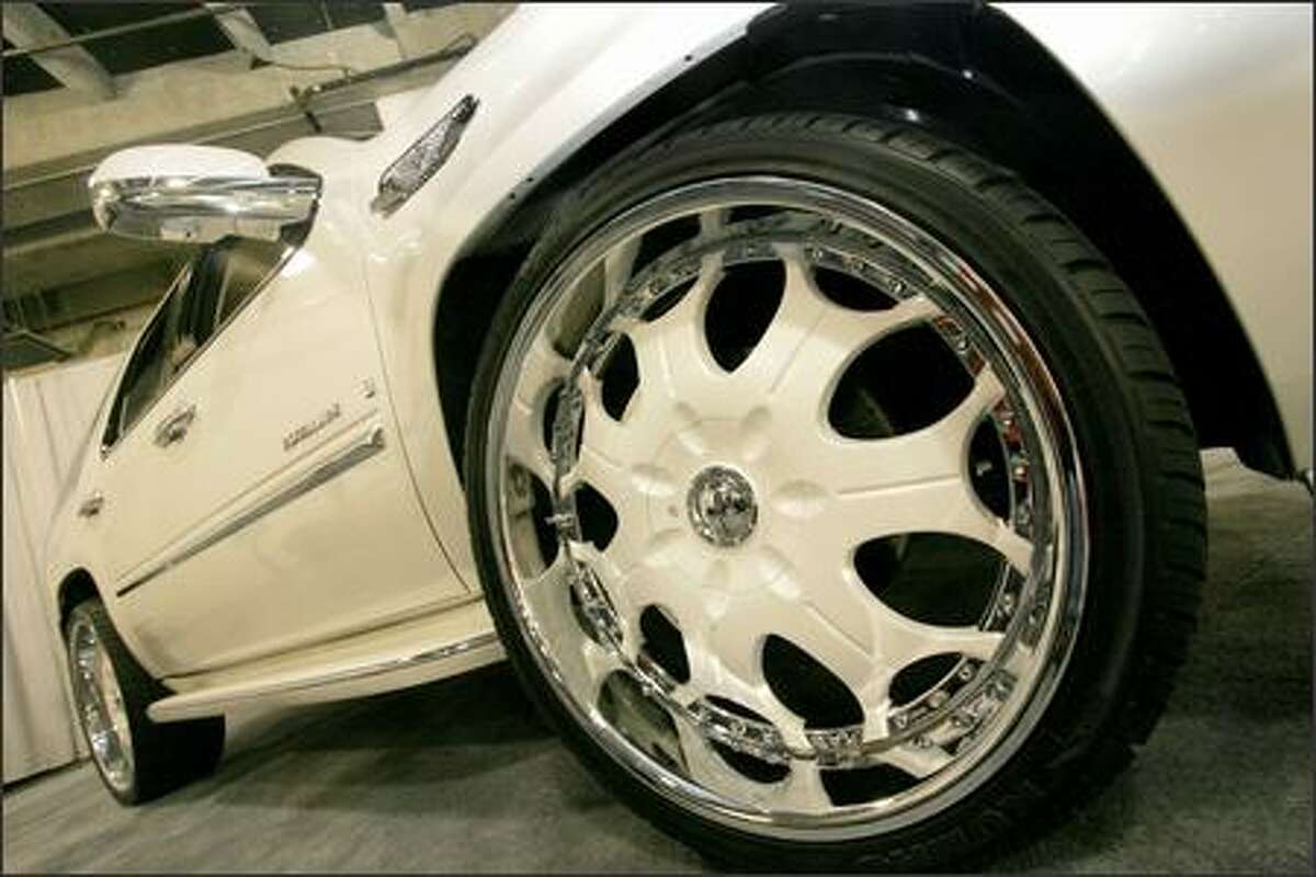 Car Nutz Customz displays 26-inch rims on a customized "Eskellade" during the Seattle Auto Show at Qwest Field Events Center.
