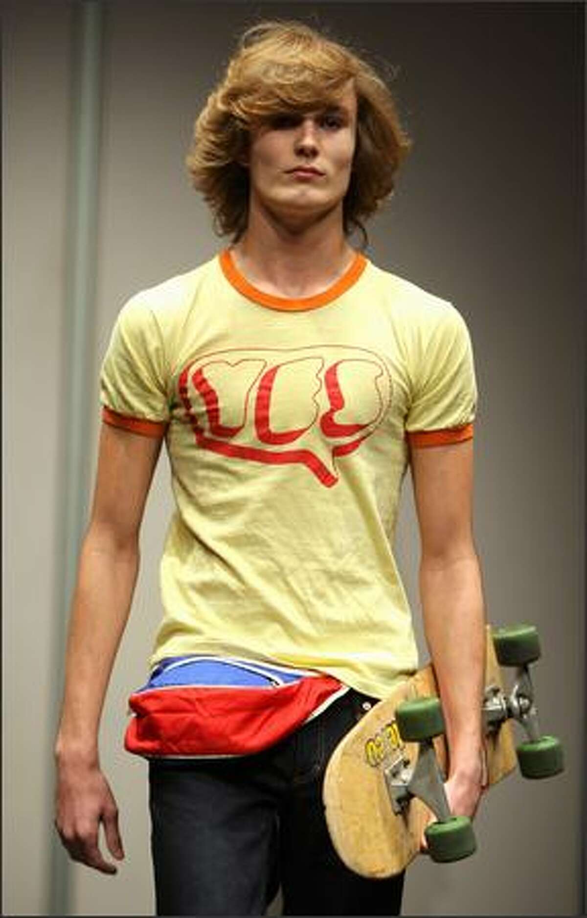 A models displays a vintage "Yes" T-shirt during a show featuring Rock and Pop memorabilia at Christie's auction house in New York, Friday. Christie's will hold an auction of 292 lots of Rock and Pop Memorabilia on 30 November 2007, ranging from vintage T-shirts, autographed pictures, original music scores to musical instruments and Gold and Platinum albums.