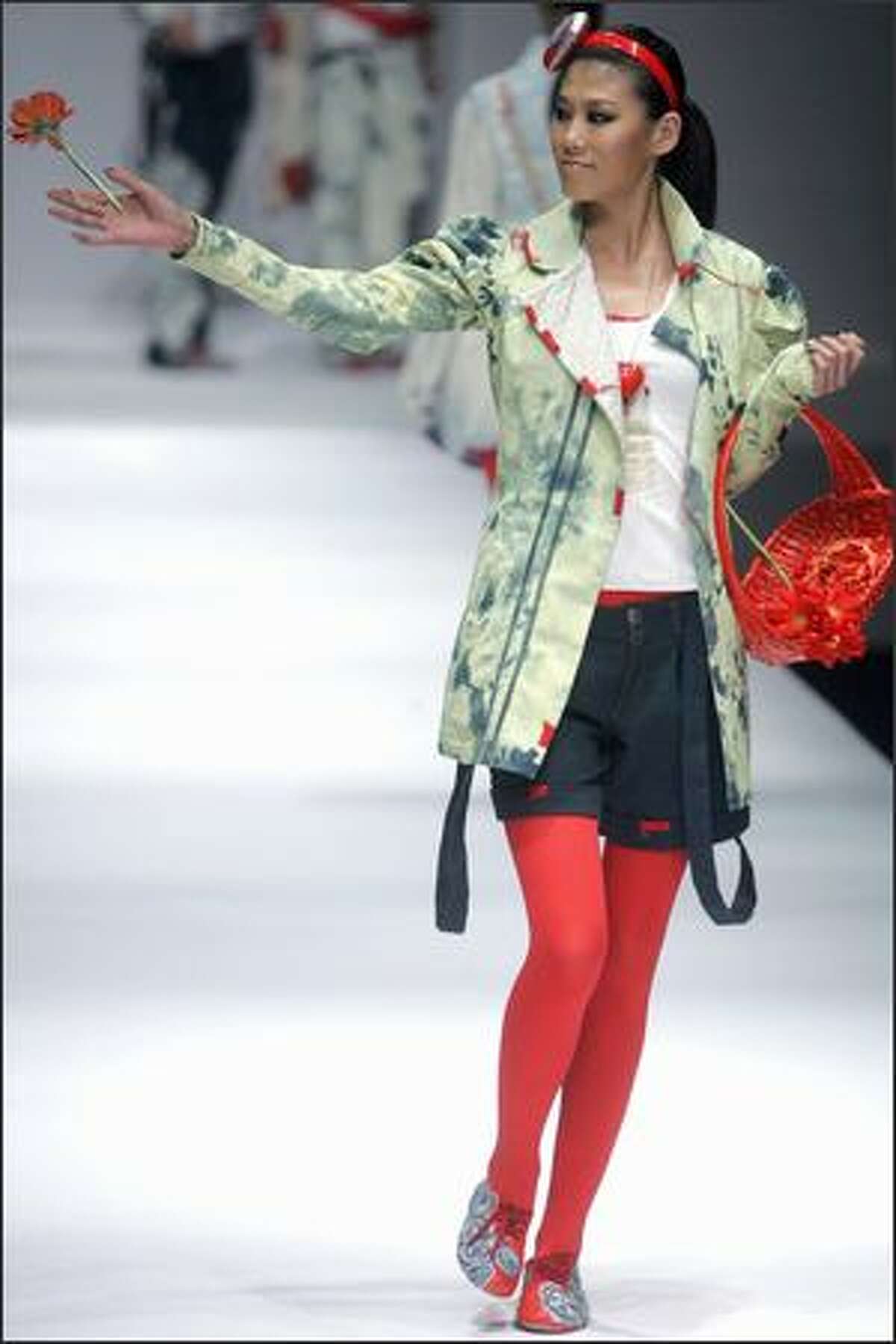 A model parades a fashion from the BICT-Raffles Design Institute at the annual China Fashion Week in Beijing.