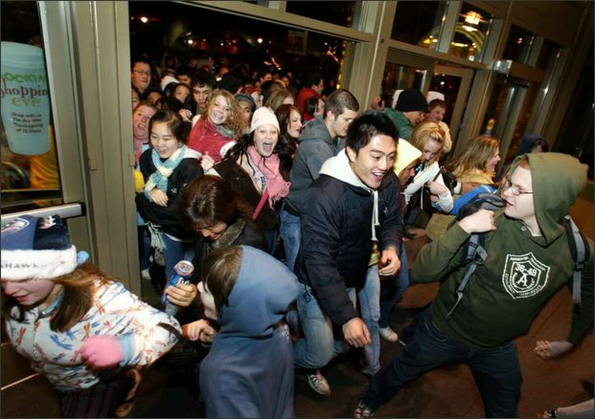 Customers burst through the doors as Alderwood Mall opens at 12:01 a.m. the day after Thanksgiving for "Black Friday" sales.
