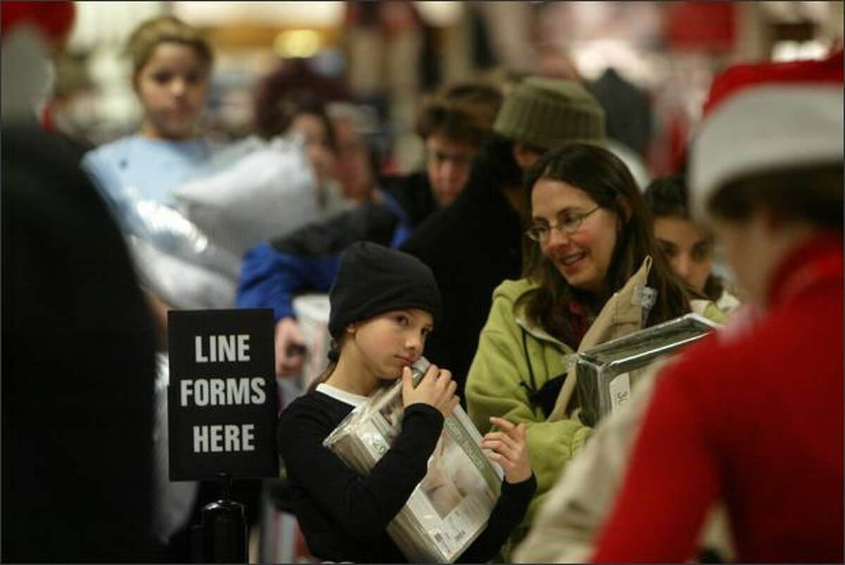 Perry Burke waits in line with her mother Julie at JCPenney at Northgate Mall in Seattle at about 5 a.m. on Friday. The store opened at 4 a.m. to accommodate the Black Friday rush.