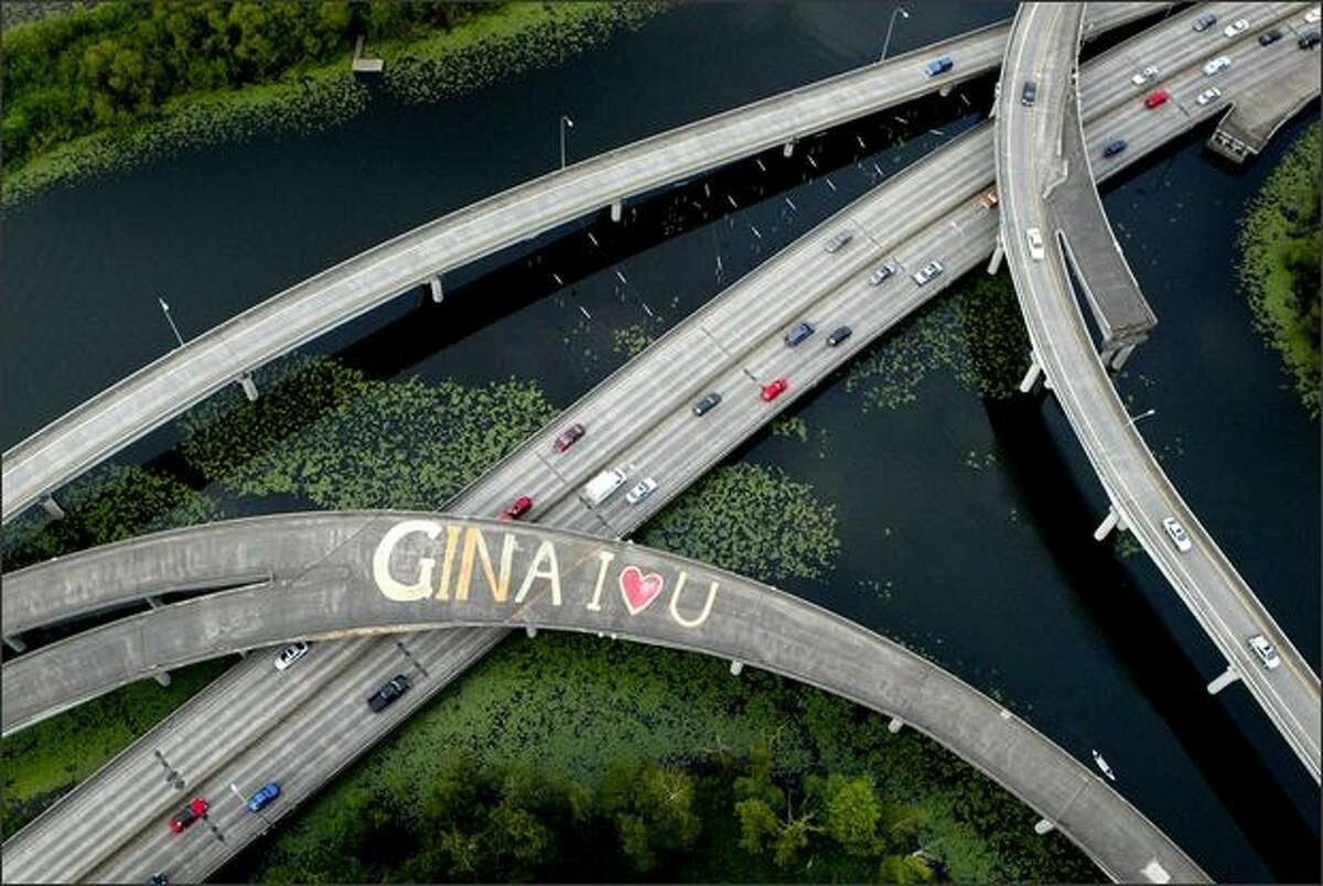 A message of love to an unknown "Gina" is scrawled across the lanes of an overpass on state Route 520 at the Arboretum in Seattle. The message was painted on an unused ramp on the highway in the serene park. The painter and the recipient of the message are mysteries.Trujillo: When flying into Sea-Tac Airport I saw this scene during the approach. I was in a commercial airliner and had only a point-and-shoot camera. The following morning I persuaded an editor to let me charter a helicopter to photograph someone's message of love -- along with some other aerial photos we needed for other stories. After the photo was published, it became one of the most viewed items on seattlepi.com that day, a rare occurrence for a single photograph. In fact, readers debated on a soundoff board in their unique fashion, wondering if it was an enchanting message of love or illegal graffiti. But even more interesting was the public interest in who Gina was. It became the subject of a talk radio show and was discussed on blogs. Someone even wrote a ballad about the message of love to Gina.