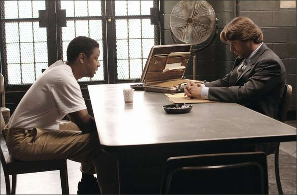 Gangster Frank Lucas (Denzel Washington, left) discusses a deal with outcast cop Richie Roberts (Russell Crowe) in "American Gangster," nominated for best motion picture -- drama.
