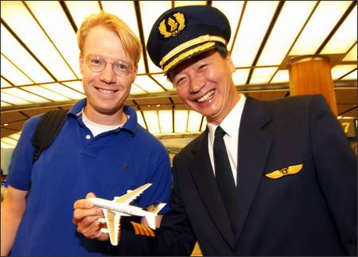 Dr. Franc Henze, an Australian surgeon set to board the airbus, poses with pilot Captain Robert Ting before the flight.