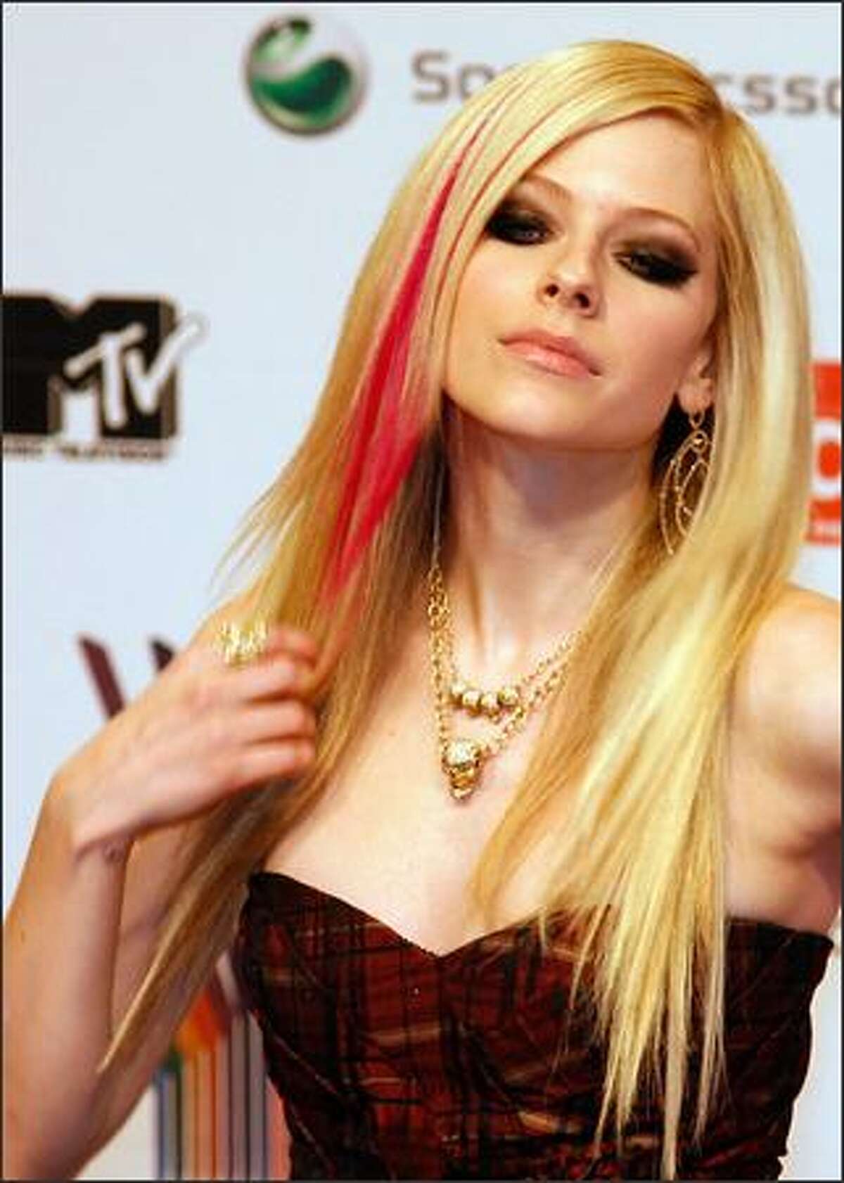 Canadian singer Avril Lavigne poses for photographers as she arrives for the MTV Europe Music Awards.