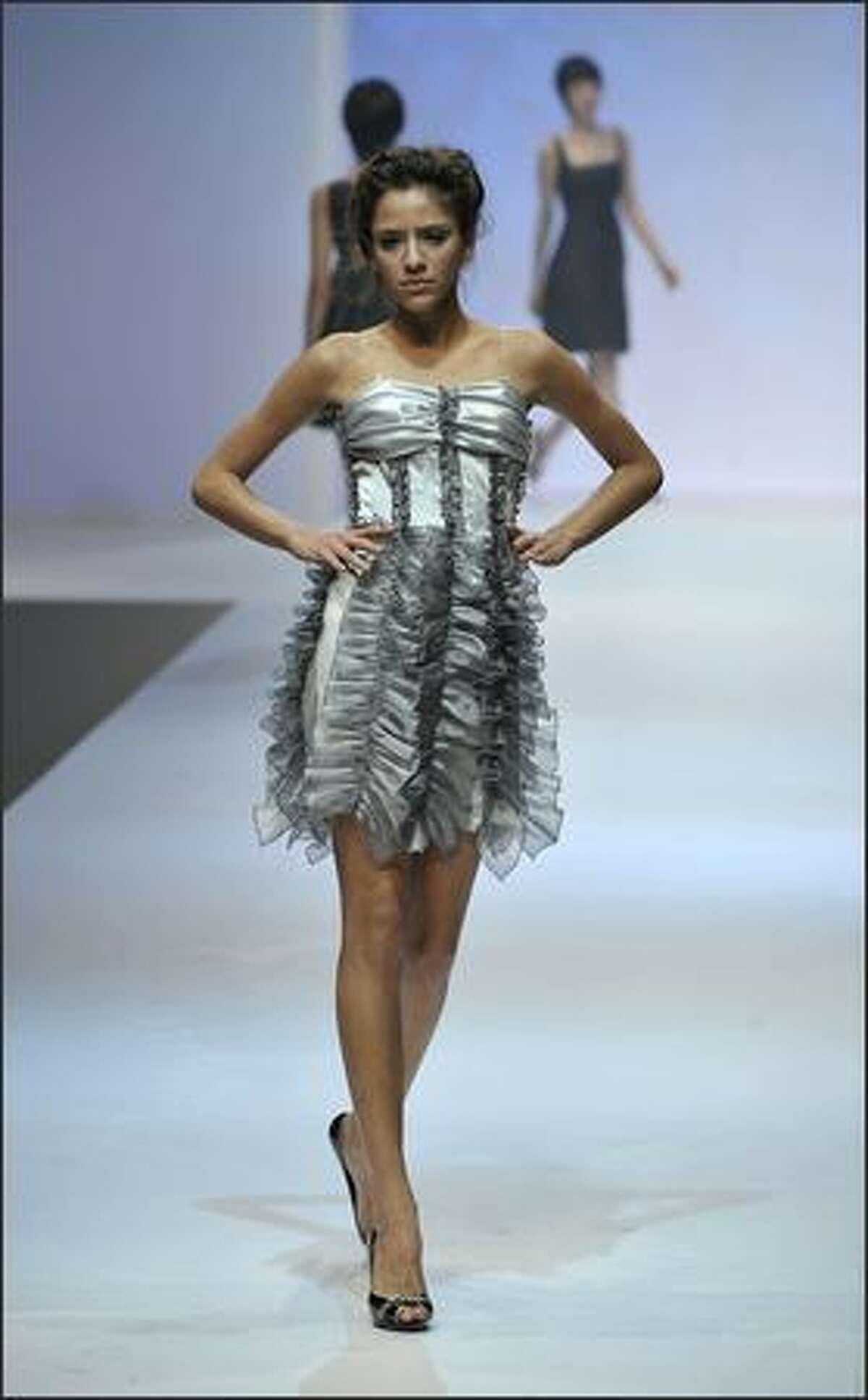 A model showcases designs on the catwalk at the Supreme Corea Artist I show by designer Ahn Yoon Yung of the Korean Women Entrepreneurs Association on the second day of Hong Kong Fashion Week Autumn/Winter 2008, at Hong Kong Convention & Exhibition Centre (HKCEC) on Tuesday in Hong Kong, China.