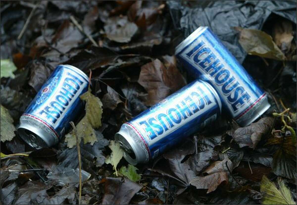 Beer cans litter the hillside where a homeless encampment is located in the hills just north of 1170 Elliott Ave.