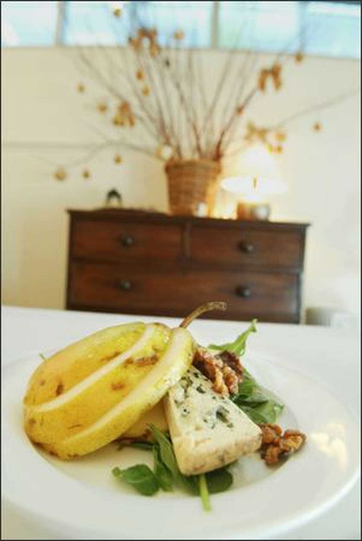 Erickson cuts pears into loose rounds for this mixed-green salad with bleu d'auvergne cheese and roasted walnuts.