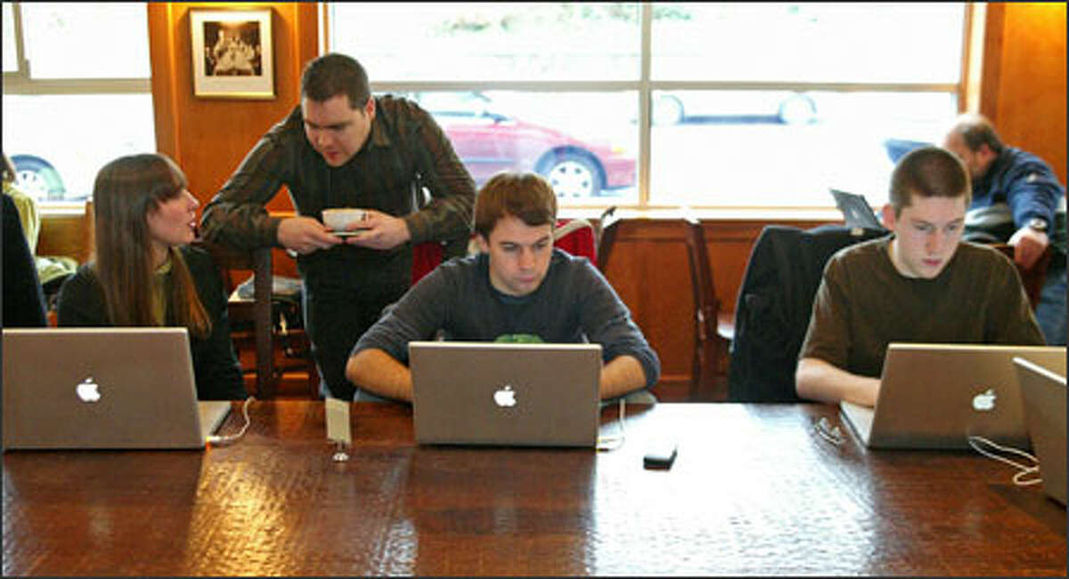 Wil Shipley, second from left, "chief monster" for Delicious Monster, talks to employees Rachel Wallace, left to right, Lucas Newman and Drew Hamlin at Zoka coffee shop.