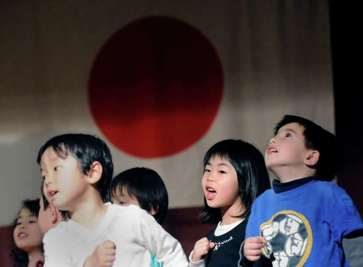 Greenwich Japanese School student Suzuha Maki, 5, second from right, performs the song, "Tomorrow," with her classmates during the Japan Earthquake and Tsunami Charity Concert at the Greenwich Japanese School, Friday night, March 18, 2011.
