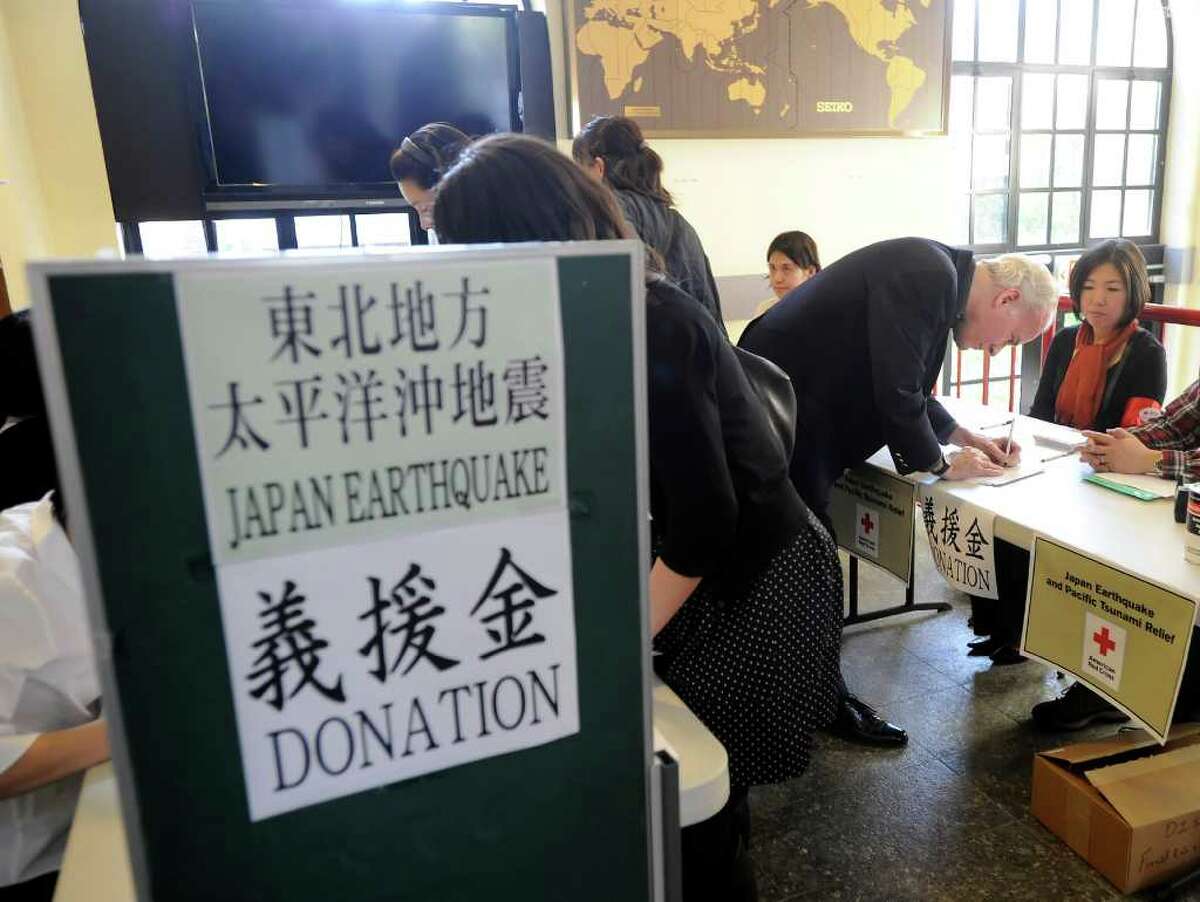 William Jarvis of Greenwich donates money during the Japan Earthquake and Tsunami Charity Concert at the Greenwich Japanese School Friday night, March 18, 2011.