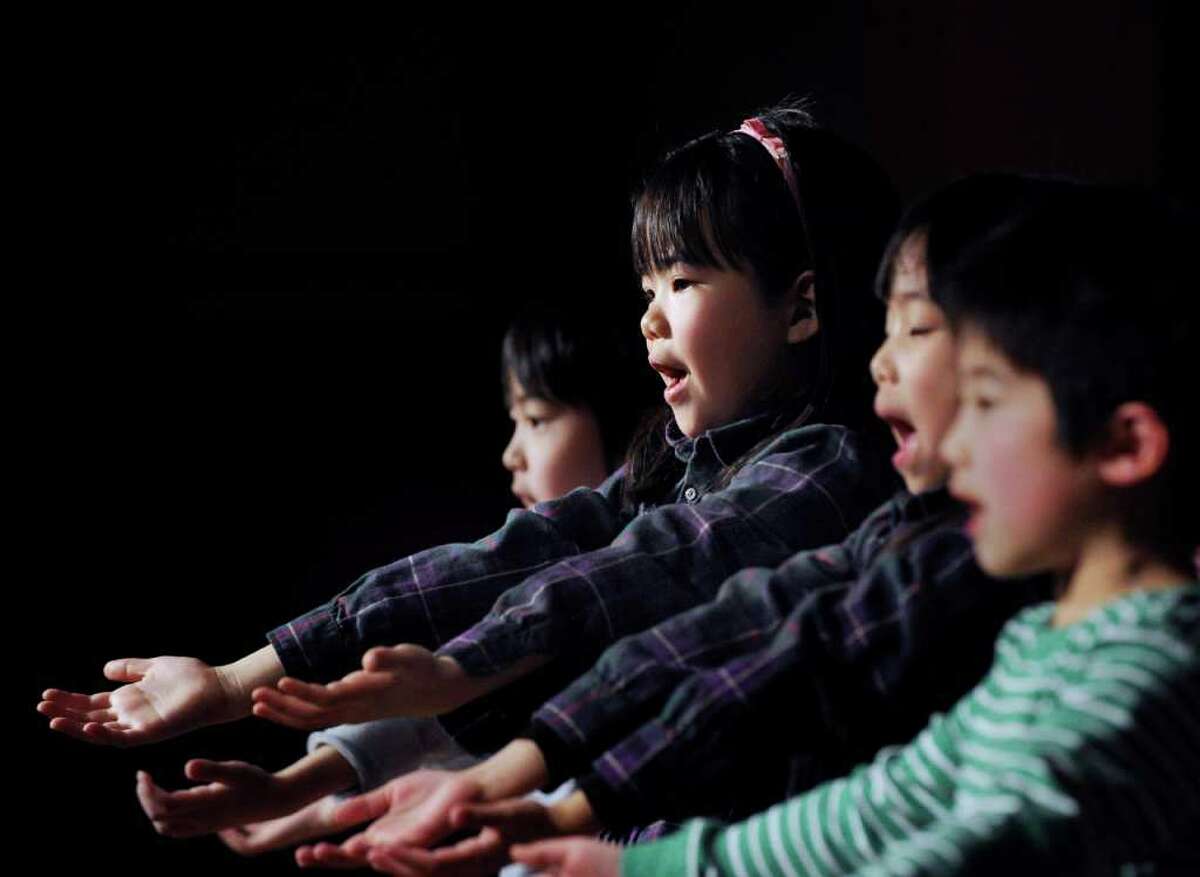 Greenwich Japanese School kindergartener Hinako Isogami, 6, performs a song with her classmates during the Japan Earthquake and Tsunami Charity Concert at the Greenwich Japanese School, Friday night, March 18, 2011.