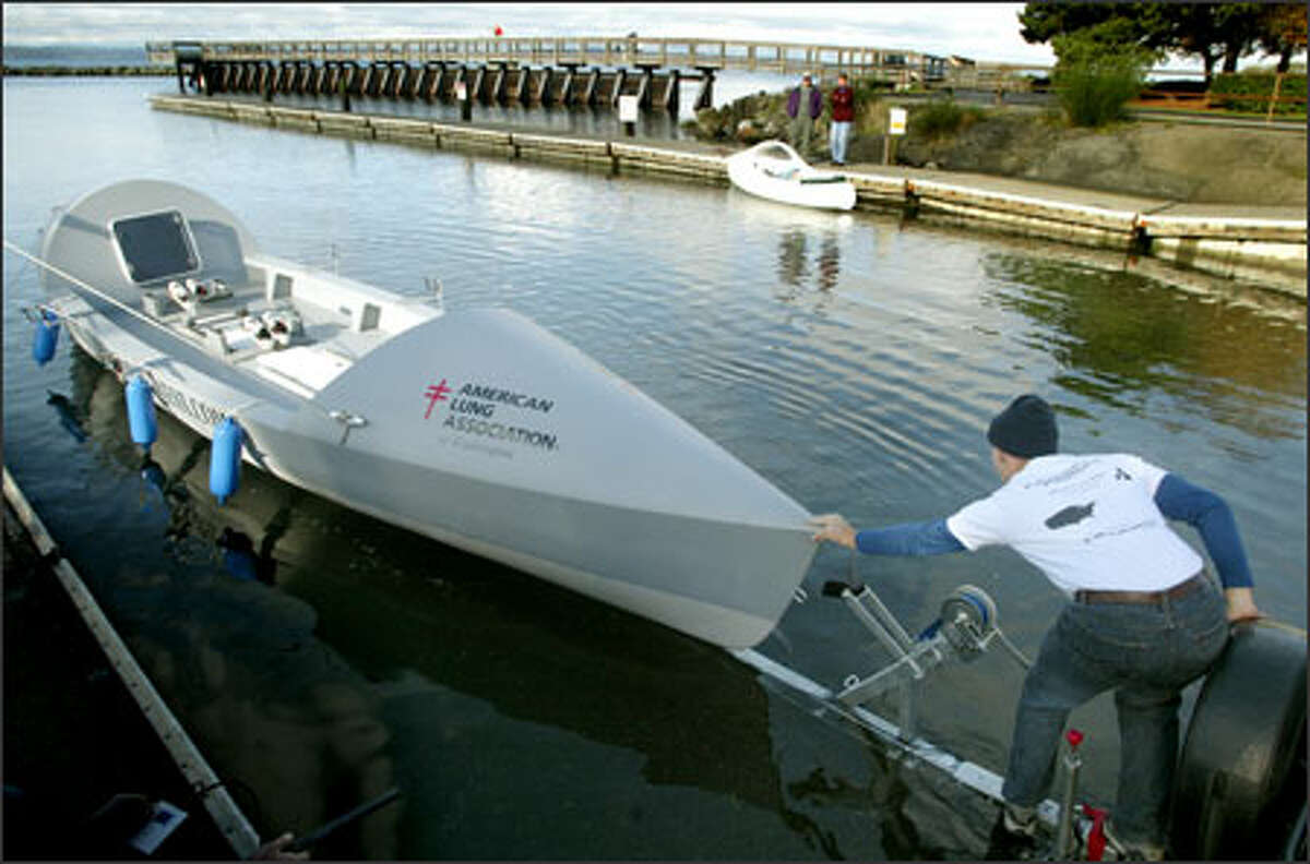Dylan LeValley helps launch the 29-foot boat he and three friends plan to row across the Atlantic Ocean as the first American team to compete in the Atlantic Ocean Fours Race.