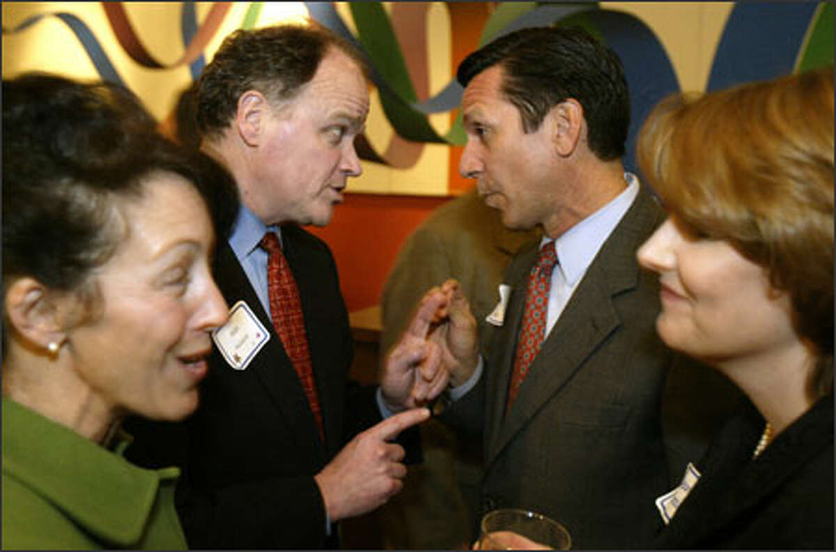 Mike McGavick talks with Dino Rossi between their wives, Gaelynn McGavick and Terry Rossi, at the GOP Lincoln Day Dinner.