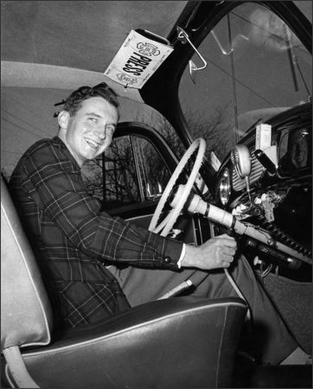 Phil H. Webber sits in his Volkswagen in this 1958 photo.