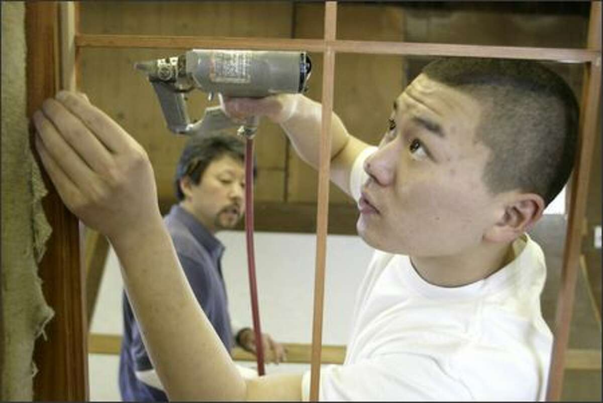 Mike Fujii and son Matt work at Bush Woodcraft in Seattle.