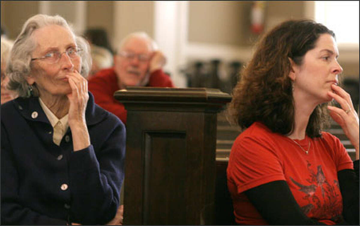 Jean Sullivan, left, and Andrea Linsky listen to a word being spelled Sunday during the regional spelling bee at Seattle's Town Hall.