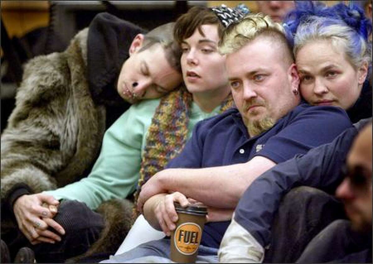 Marc Verebely, left, Jessica Ritland, Chris St. Peter and Cerulleal Saturnine attend a public meeting Tuesday at the Miller Community Center on Capitol Hill. Verebely and Ritland were in the house during Saturday's shooting rampage, which left seven dead. Saturnine lived in the house but was not there when the shooting took place.