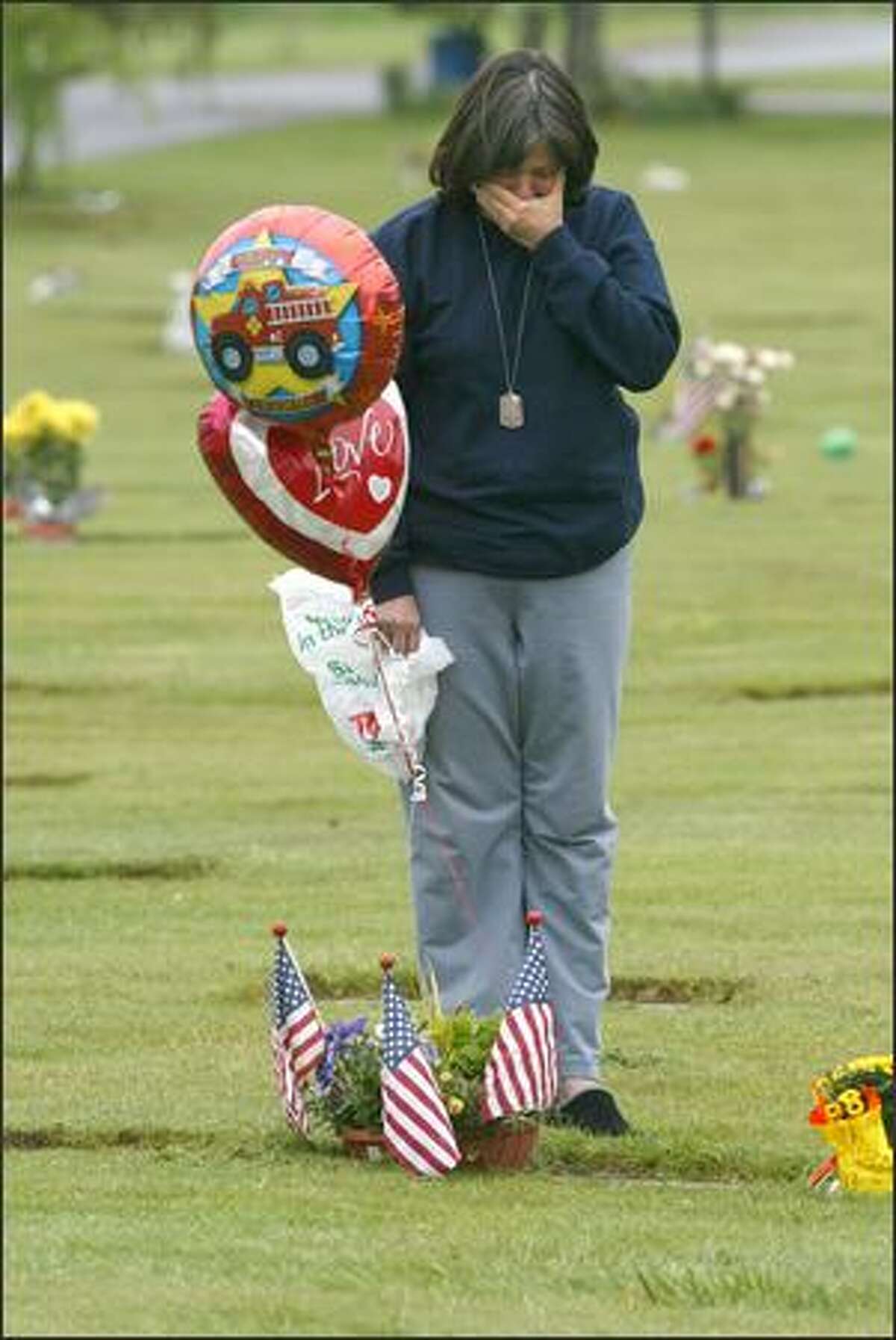 Shellie Starr drops off birthday balloons at the gravesite of her son, Jeff, at the Grand Army of the Republic Cemetery. On Thursday, Starr would have turned 23. Starr was killed last year on Memorial Day, just two days before he would have returned to civilian life.