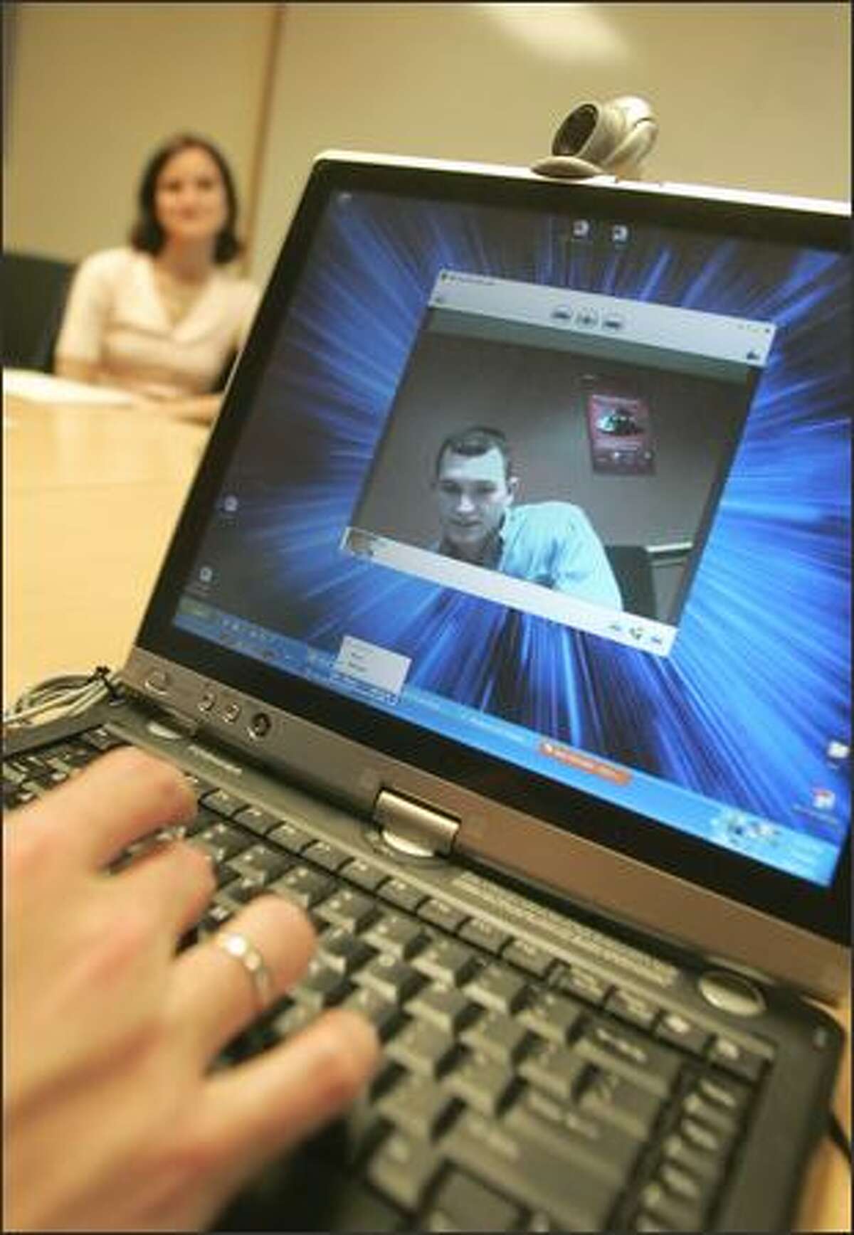 Michael Cowan, product marketing manager for Microsoft Hardware, demonstrates a Webcam the company is creating.