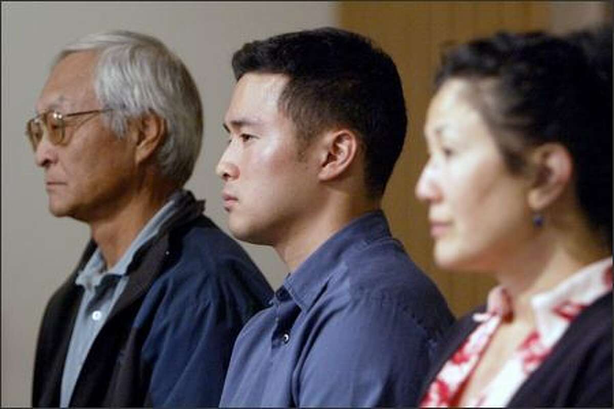 Lt. Ehren Watada is flanked by his father, Robert Watada, and his mother, Carolyn Ho, at Seattle's University Lutheran Church Monday.