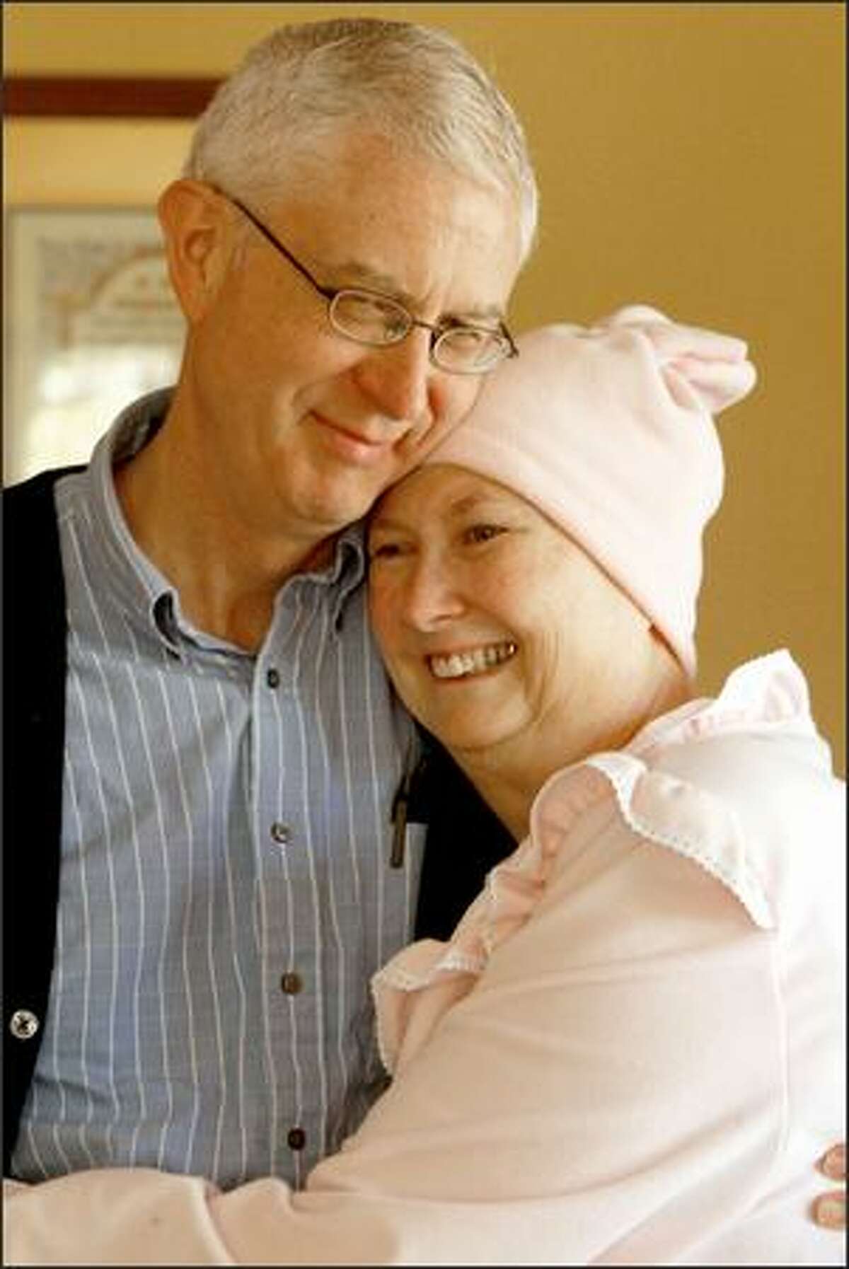 Neil Faulkner gives his wife, Kay, a big hug after the massage session is over. Kay Faulkner, 59, is dying of ovarian cancer; massage eases her pain.
