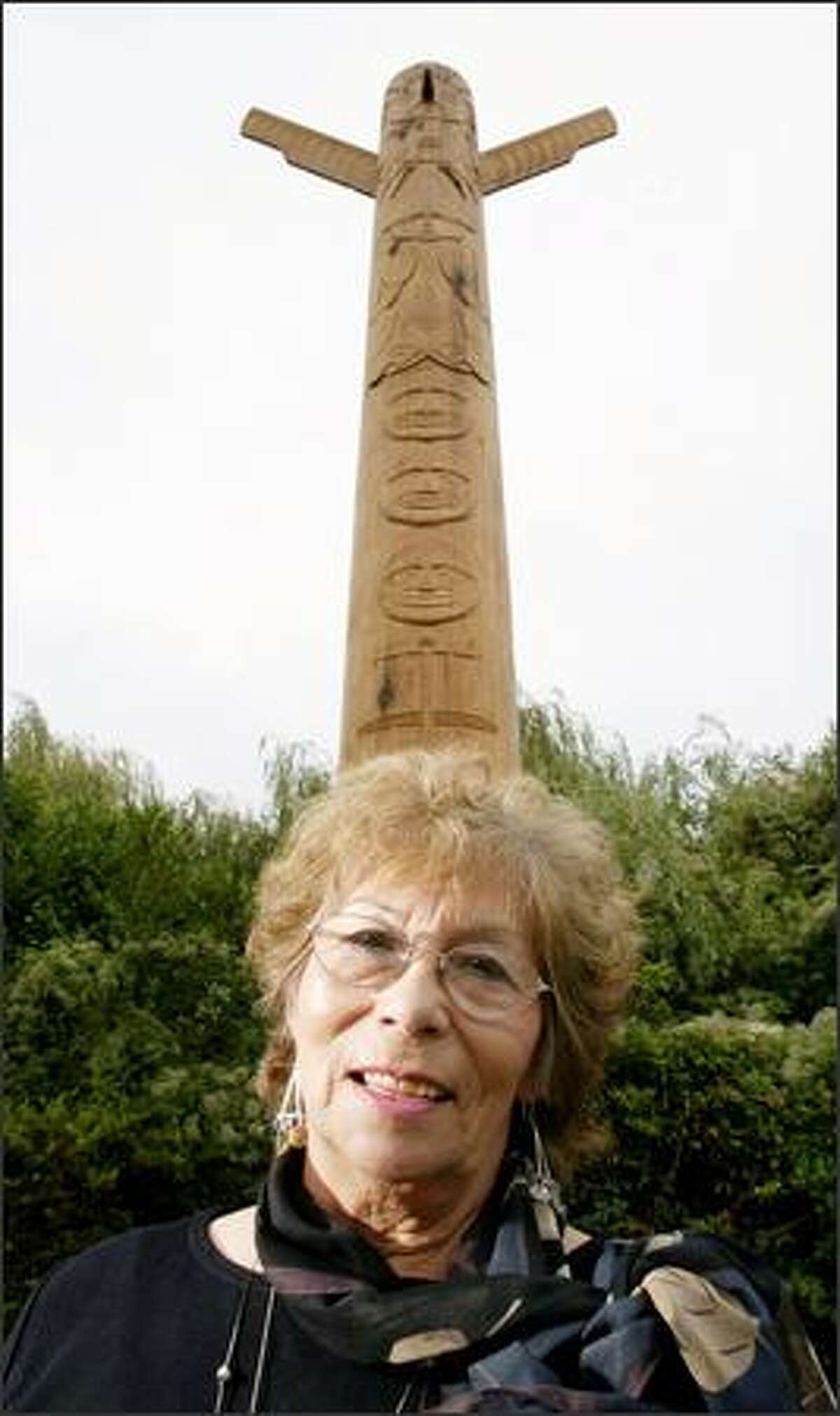 Duwamish Tribal Chairwoman Cecile Hansen poses in front of the new totem pole erected at the Admiral Way Viewpoint, 3600 Admiral Way S.W., in West Seattle.