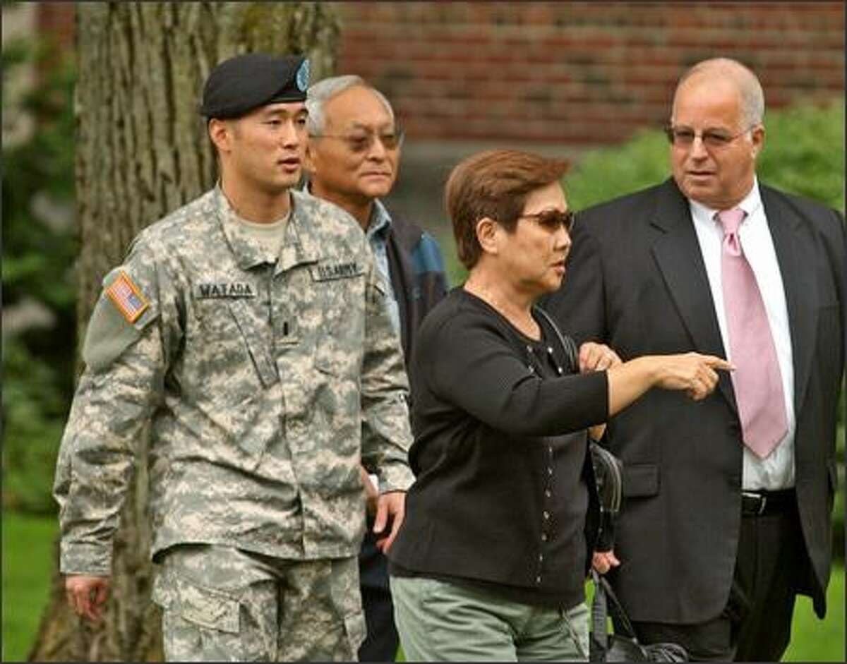 Lt. Ehren Watada, left, walks with his father, Bob Watada; his stepmother, Rosa Sakanishi; and attorney Eric Seitz during a lunch break in an Army hearing on Watada's refusal to deploy to Iraq.
