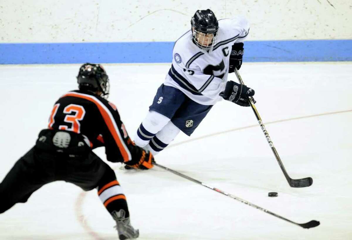 Staples' Tali Laifer controls the puck as Watertown-Pomperaug's Kyle Block defends during the Division III state playoff game at Yale University's Ingalls Rink Saturday, Mar. 19, 2011.