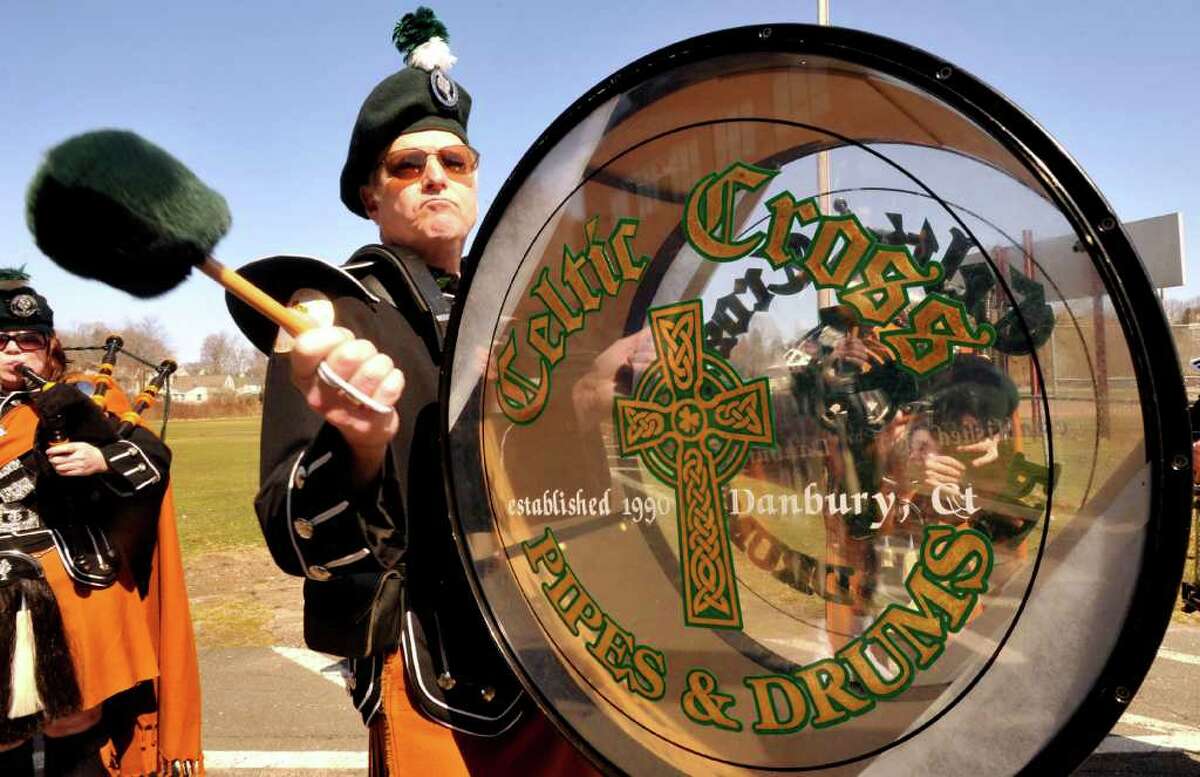 Tom Wall beats a drum with the Celtic Cross Pipes & Drums of Danbury that marched in the Ancient Order of the Hibernian's St. Patrick's Day parade in Danbury, Sunday, March 20, 2011.