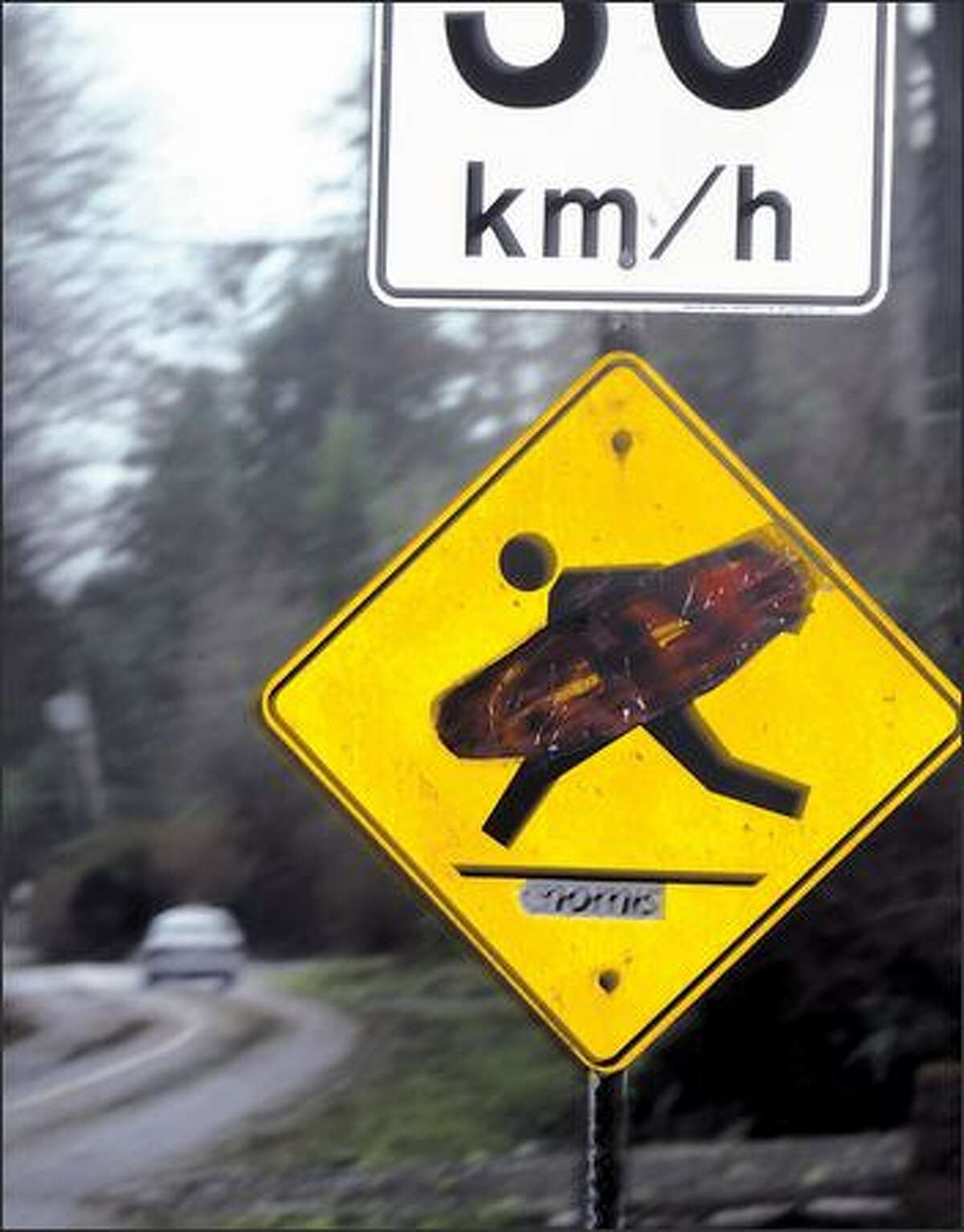 A street sign reflects the surfing culture of Tofino, B.C.