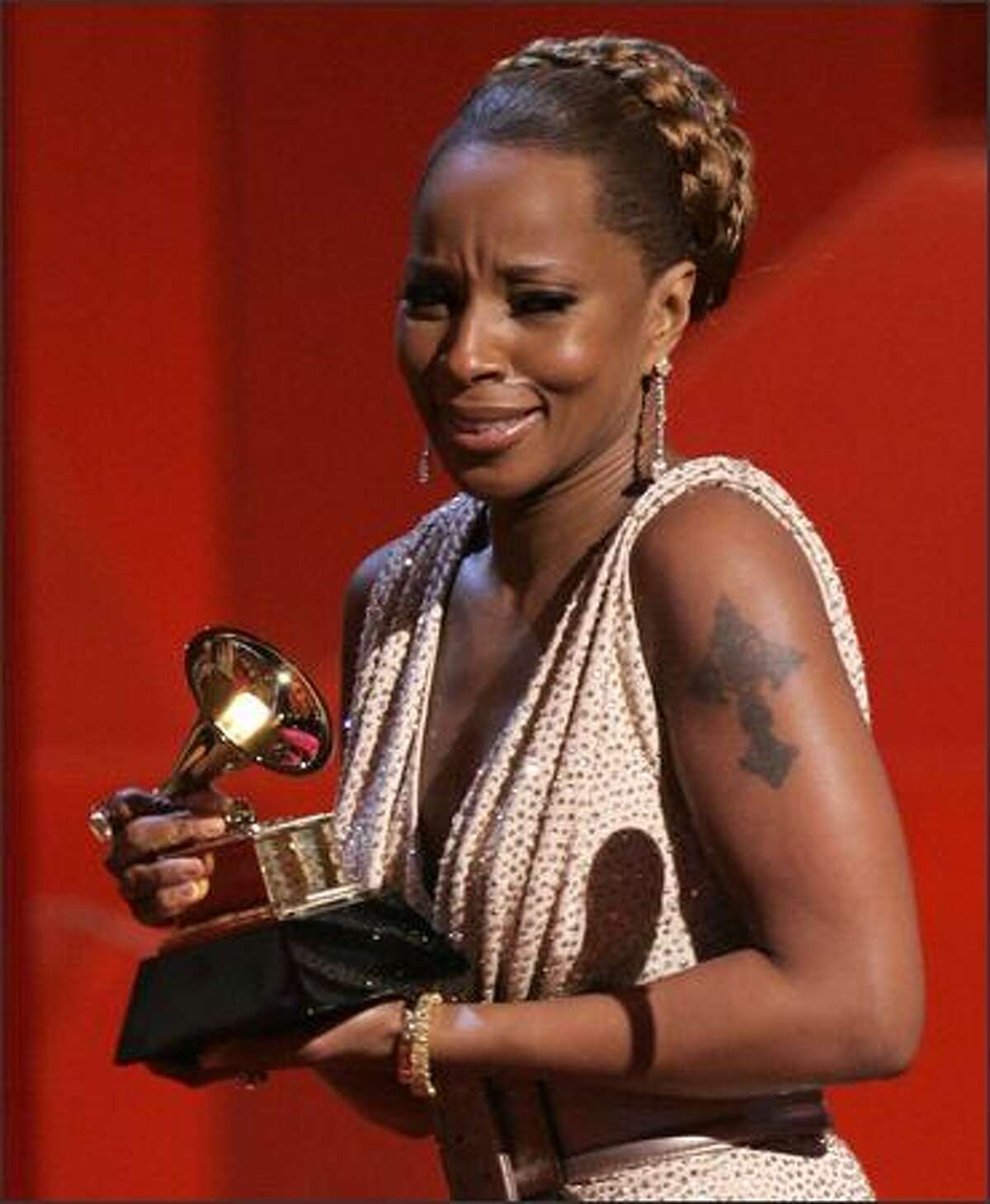A tearful Mary J. Blige accepts the award for best female R&B vocal performance for "Be Without You."