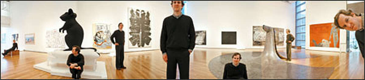 In this panorama photo, Michael Darling, curator of contemporary art in the new Wright Galleries for Modern and Contemporary Art, is shown with, from left: "Black Series: Coulures Noires" by Ghada Amer; "To Add One Meter to an Anonymous Mountain" by Zhang Huan; "Blue and Gold in Short Skirt" by Sue Williams; "Mann und Maus" by Katharina Fritsch; "On the Wall Above" by Sean Landers; "Rorschach" by Andy Warhol; "An Exhibition of Gasoline Powered Engines" by Ed Ruscha; "Stranger in the Village (Excerpt) #7" by Glenn Ligon; "Some/One" by Do-Ho Suh; "Die Welle (Wave)" by Anselm Kiefer and "White Squad II" by Leon Golub. P-I photographer Mike Urban shot seven individual vertical photos of Darling, panning the camera on a tripod each time. Using the Photomerge software included in Photoshop, he stitched the multiple photos into one.