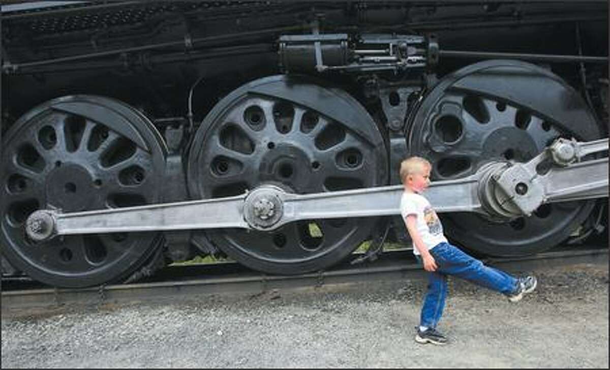 Five-year-old Stephen Breckenridge of Mount Vernon marches along as he gets a look Wednesday at Steam Locomotive No. 844, the last steam locomotive built for Union Pacific Railroad. It was delivered in 1944. It is currently on display at the rail yard in Fife, along with other steam locomotives.