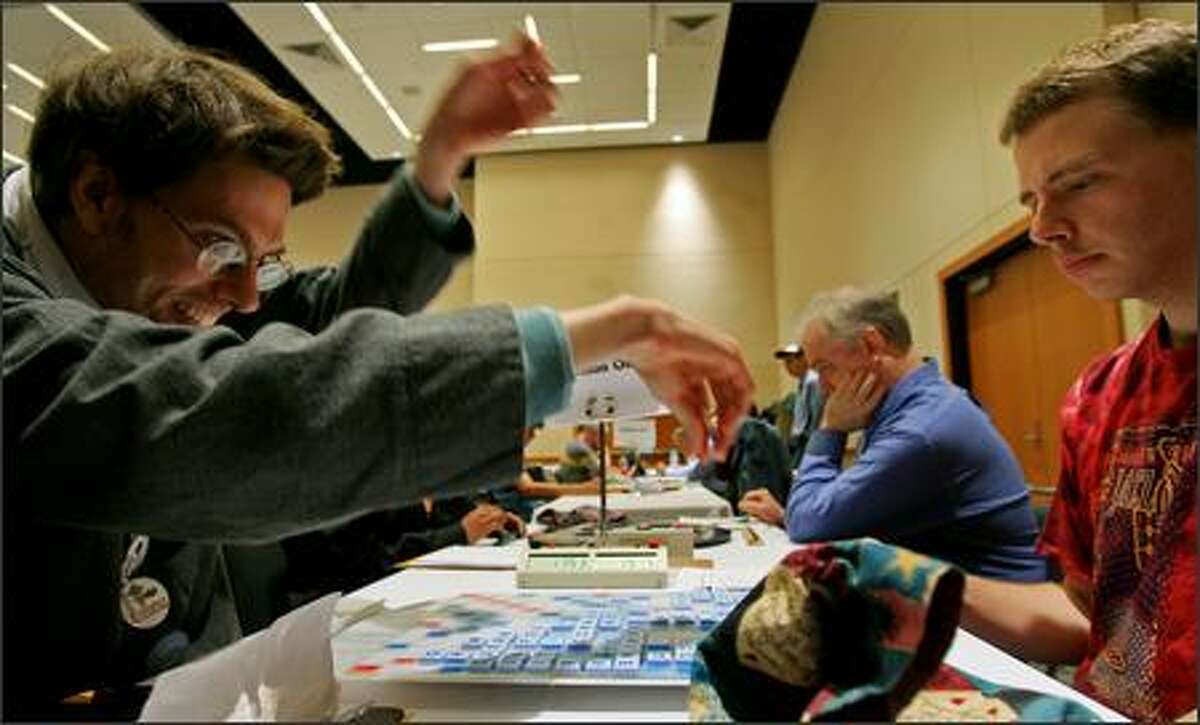 An enthusiastic Daniel Goodwin of Montlake spells "nisei" and scores 41 points against Dave Wiegand of Portland during Seattle Scrabble Club's annual tournament in Lynnwood on Sunday. Wiegand defeated Goodwin 419-415.