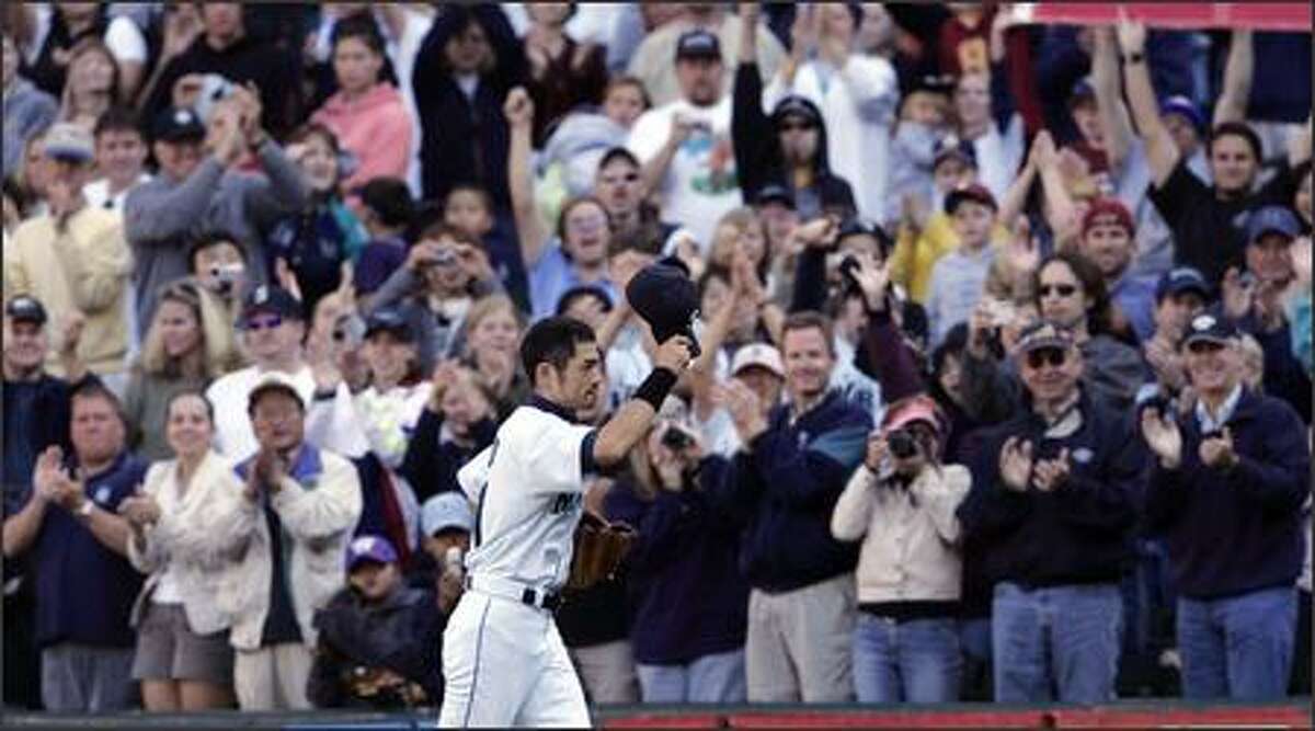 Ichiro Suzuki waves his cap to fans as he leaves the field during a game at Safeco Field late in the 2004 season. Many Mariners fans would relish the chance to see Ichiro play his entire big league career here.