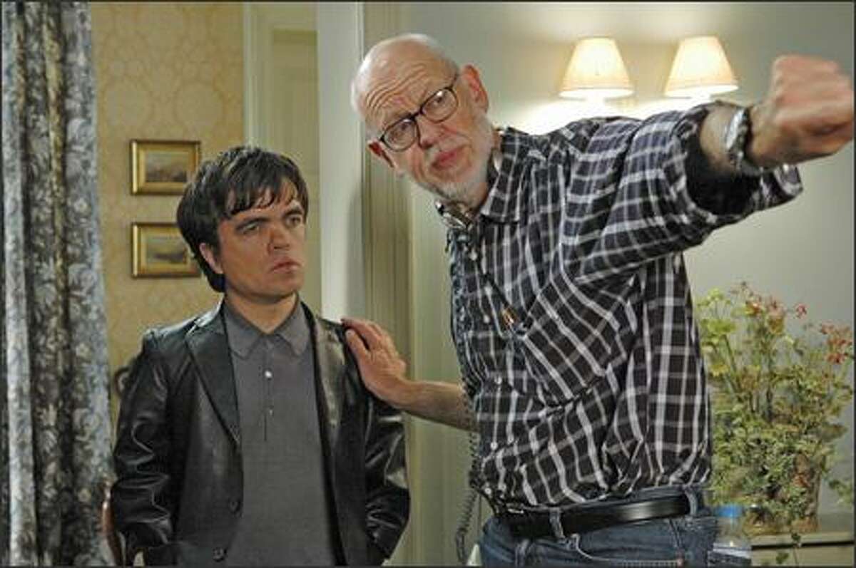 Frank Oz, right, directs Peter Dinklage on the set of "Death at a Funeral," a very English ensemble piece.
