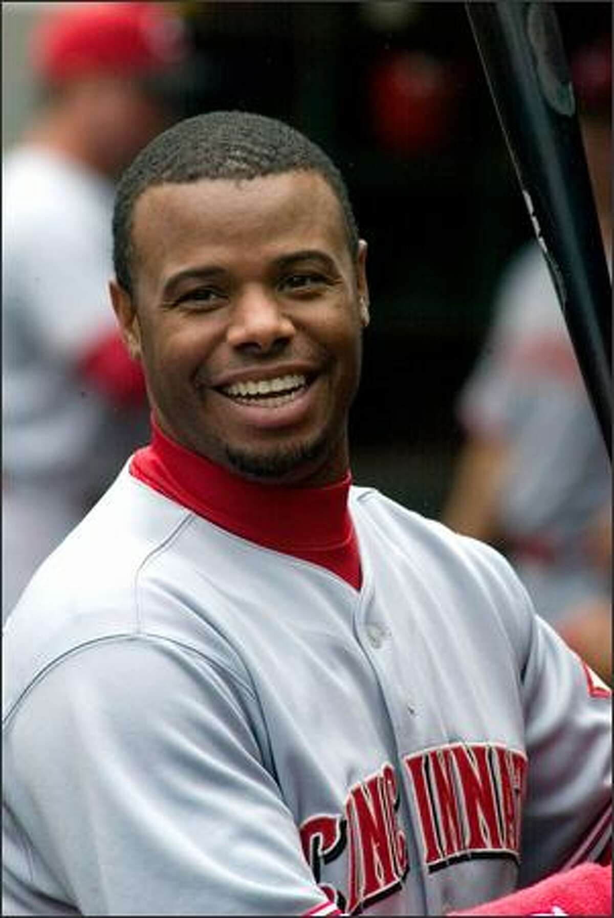 Ken Griffey Jr., smiles before his team, the Cincinnati Reds, take the field against the Mariners.
