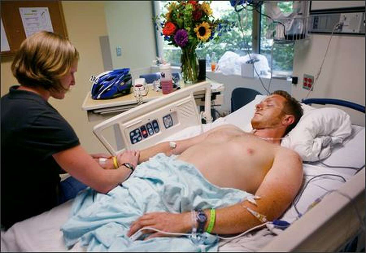 Gerald Marvin visits with girlfriend Amber Brinkman Monday after a car hit him on his ride in the Seattle to Portland bike marathon.