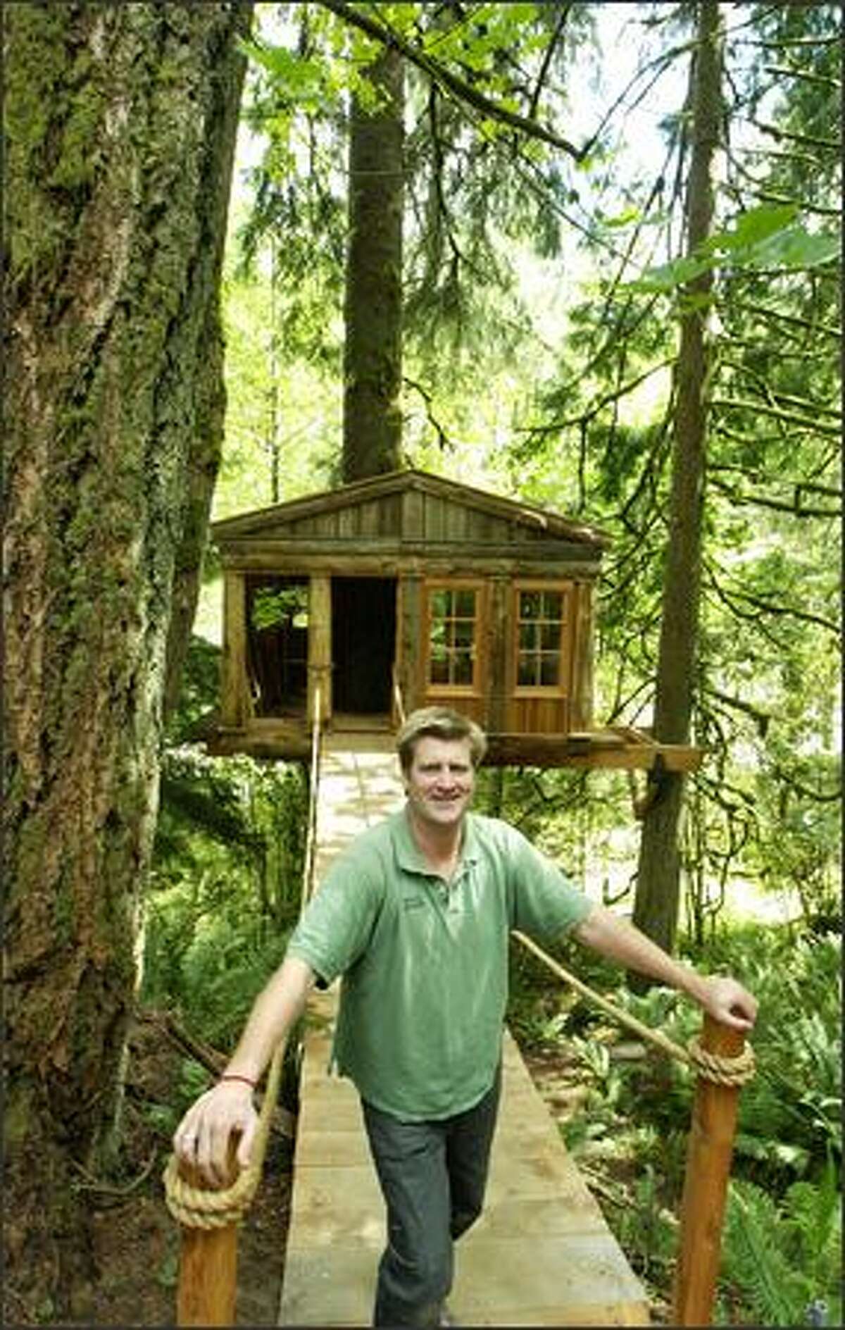 TreeHouse Workshop co-owner Pete Nelson stands in front of one of the treehouses built by participants in his workshop.