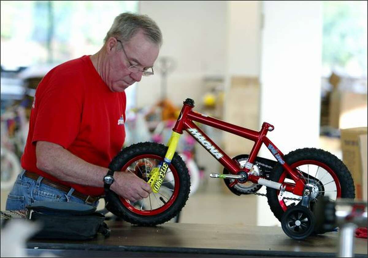 Volunteer Steve Day works on a bike the Forgotten Children's Fund will give away.