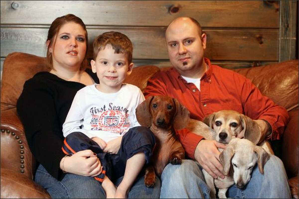 Paige and Buck MacMillan with their son Isaac, 3, and their three dogs. Burglars ransacked the family's home in Magnolia.