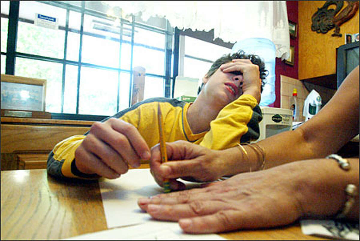 Anthony Duncan shows a little strain while studying with his mother.Webber: Sometimes it helps to have a personal connection to a story. That happened with Anthony Duncan, a 13-year-old with severe dyslexia who is struggling to live with the condition. I have mild dyslexia and asked for the assignment. Off and on for eight months I followed Anthony’s life with a greater understanding than another photographer might have had. In this picture, Anthony was studying with his mother.